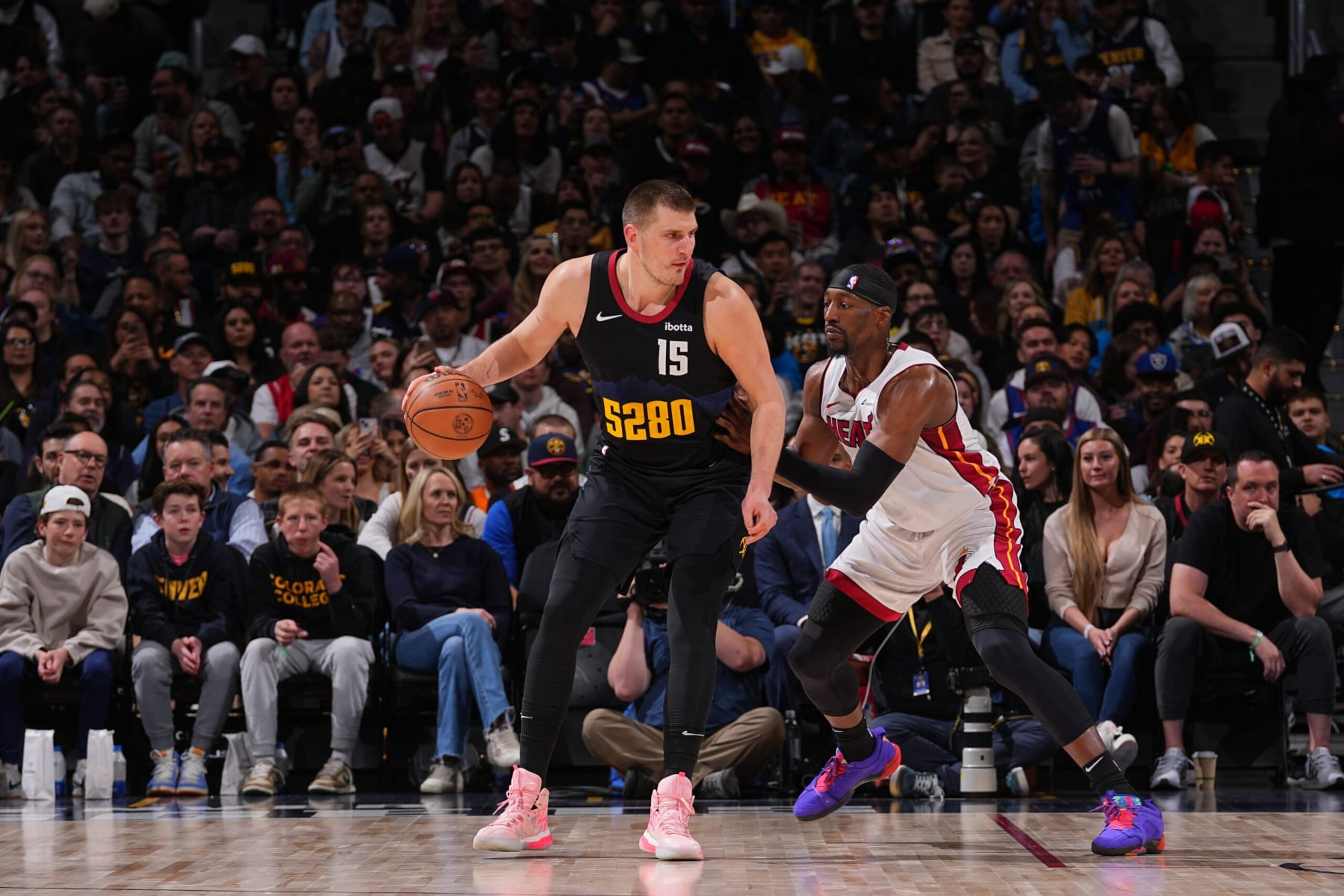 DENVER, CO - FEBRUARY 29: Nikola Jokic #15 of the Denver Nuggets handles the ball against Bam Adebayo #13 of the Miami Heat during the game on February 29, 2024 at the Ball Arena in Denver, Colorado. NOTE TO USER: User expressly acknowledges and agrees that, by downloading and/or using this Photograph, user is consenting to the terms and conditions of the Getty Images License Agreement. Mandatory Copyright Notice: Copyright 2024 NBAE (Photo by Bart Young/NBAE via Getty Images)