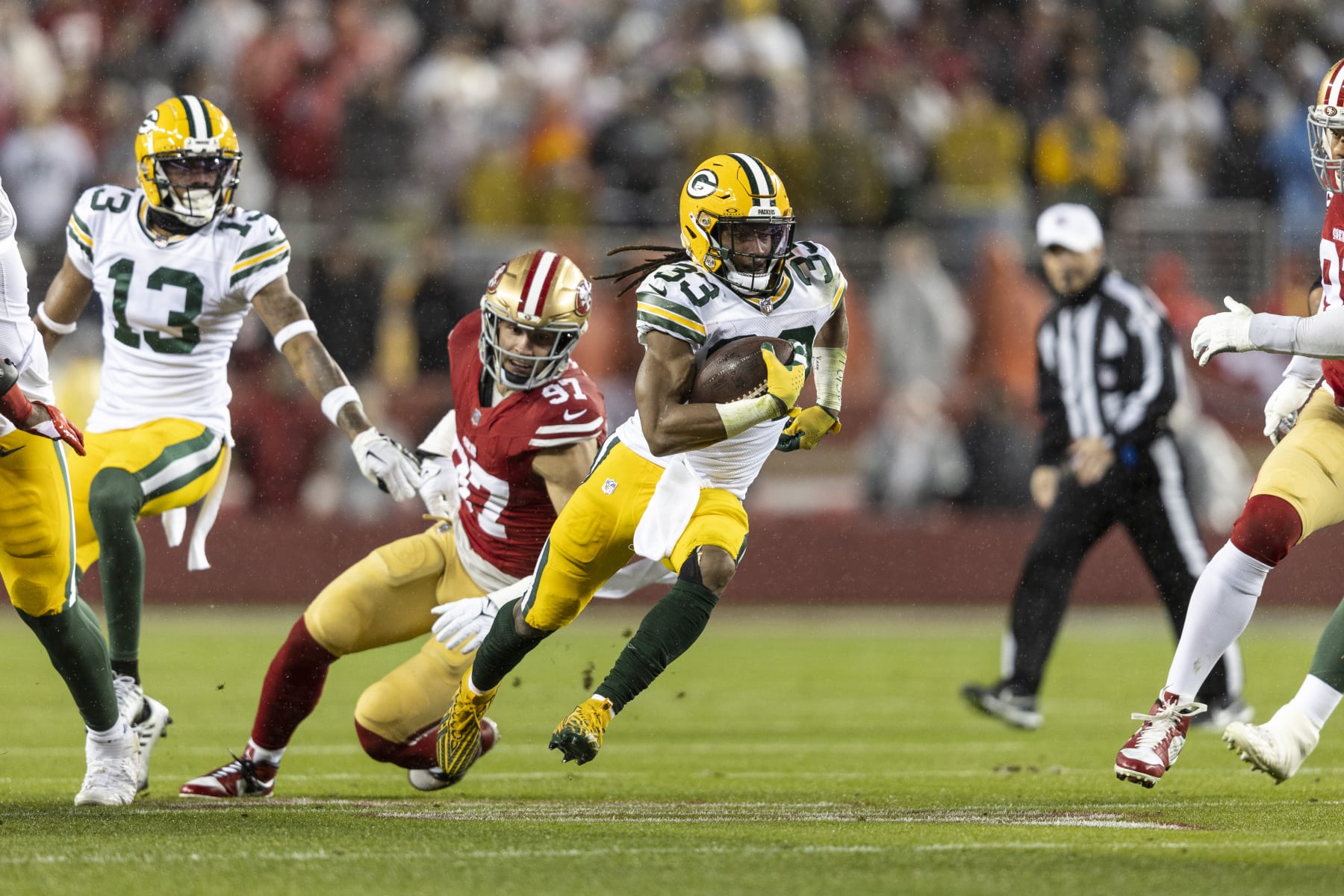 SANTA CLARA, CALIFORNIA - JANUARY 20: Aaron Jones #33 of the Green Bay Packers runs with the ball during an NFL divisional round playoff football game between the San Francisco 49ers and the Green Bay Packers at Levi's Stadium on January 20, 2024 in Santa Clara, California. (Photo by Michael Owens/Getty Images)