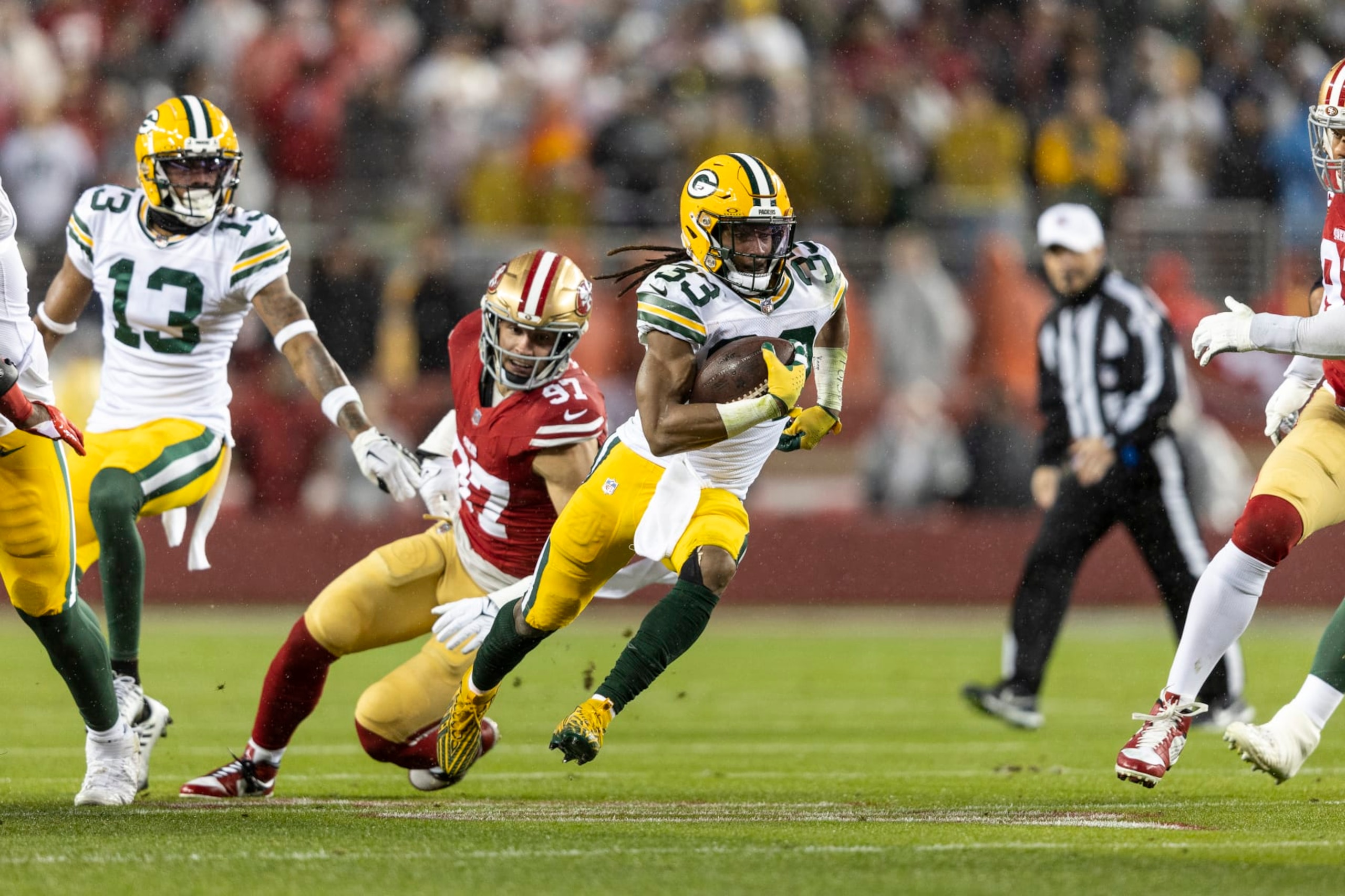 SANTA CLARA, CALIFORNIA - JANUARY 20: Aaron Jones #33 of the Green Bay Packers runs with the ball during an NFL divisional round playoff football game between the San Francisco 49ers and the Green Bay Packers at Levi's Stadium on January 20, 2024 in Santa Clara, California. (Photo by Michael Owens/Getty Images)