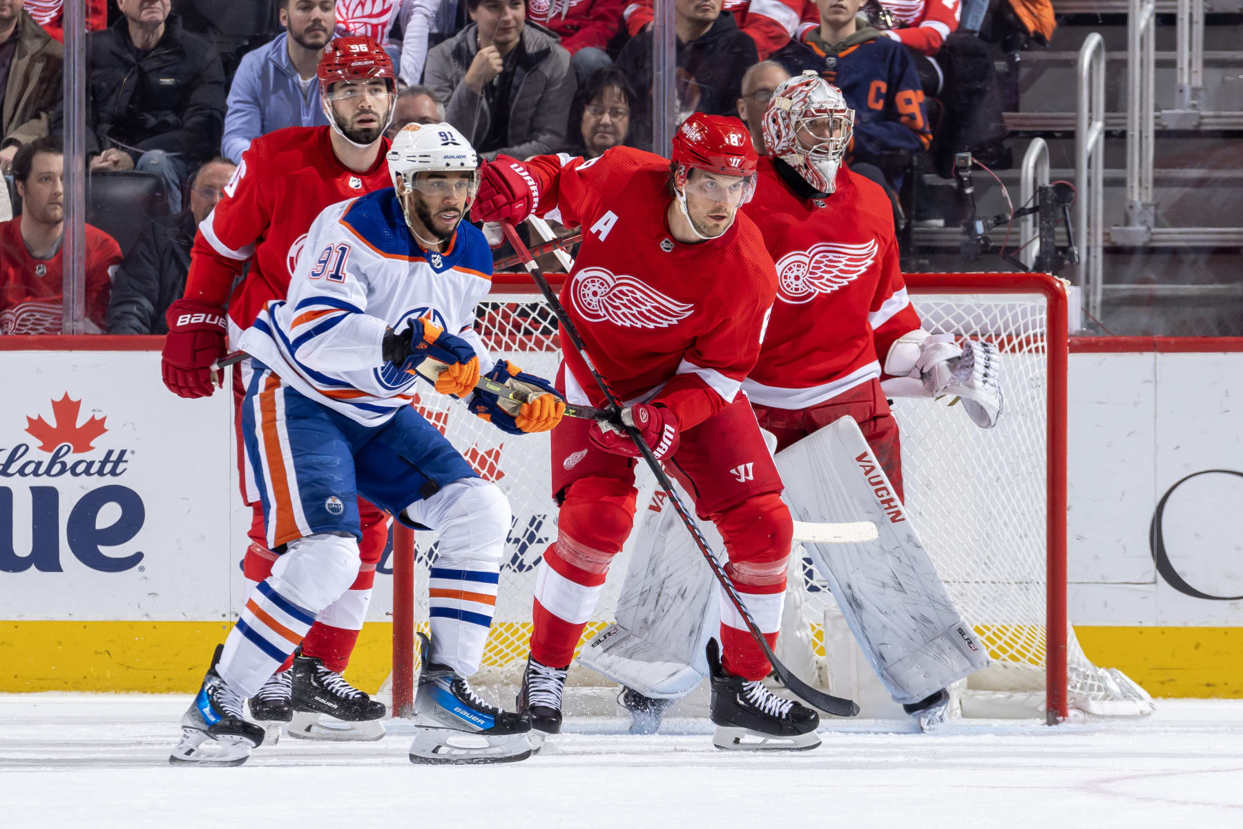 DETROIT, MI - JANUARY 11: Goalie Alex Lyon (34) of the Detroit Red Wings and teammate Ben Chiarot (8) follow the puck as Evander Kane (91) of the Edmonton Oilers battles for position during the first period at Little Caesars Arena on January 11, 2024 in Detroit, Michigan. (Photo by Dave Reginek/NHLI via Getty Images)