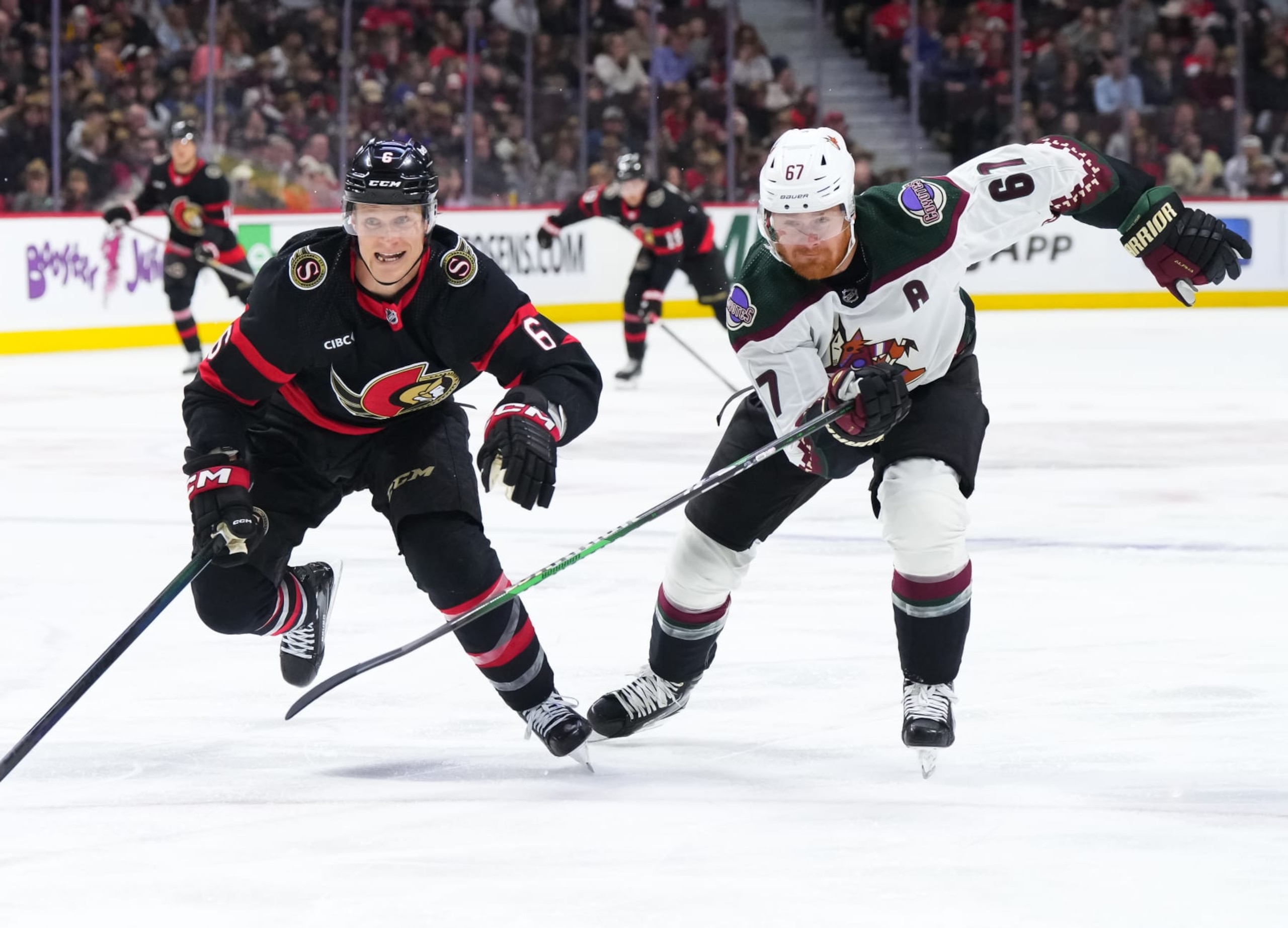 OTTAWA, CANADA - MARCH 1: Jakob Chychrun #6 of the Ottawa Senators skates against Lawson Crouse #67 of the Arizona Coyotes during the second period at Canadian Tire Centre on March 1, 2024 in Ottawa, Ontario, Canada.  (Photo by Andrea Cardin/NHLI via Getty Images)