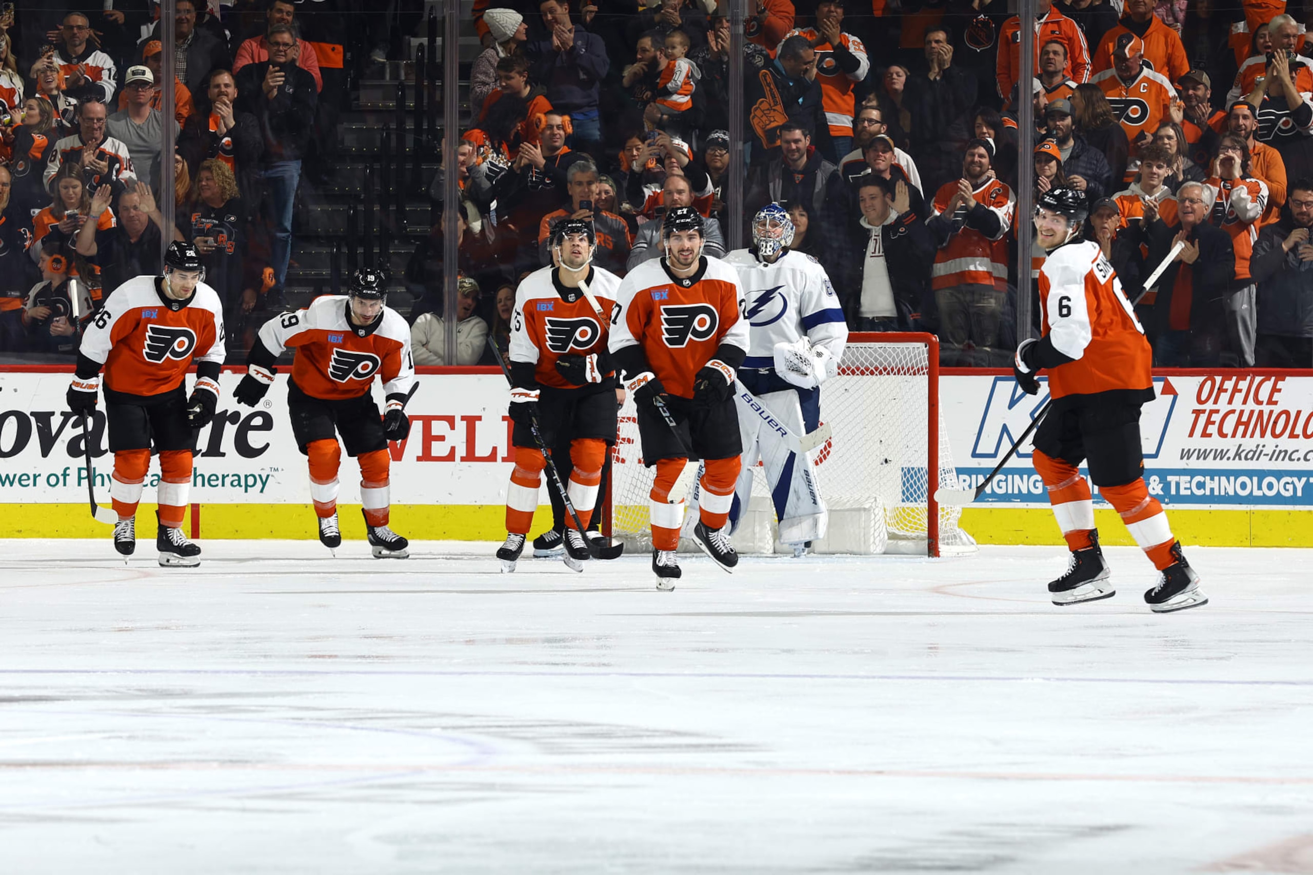PHILADELPHIA, PENNSYLVANIA - FEBRUARY 27: Travis Sanheim #6 of the Philadelphia Flyers (R) reacts with teammates after scoring during the third period against the Tampa Bay Lightning at the Wells Fargo Center on February 27, 2024 in Philadelphia, Pennsylvania. (Photo by Tim Nwachukwu/Getty Images)