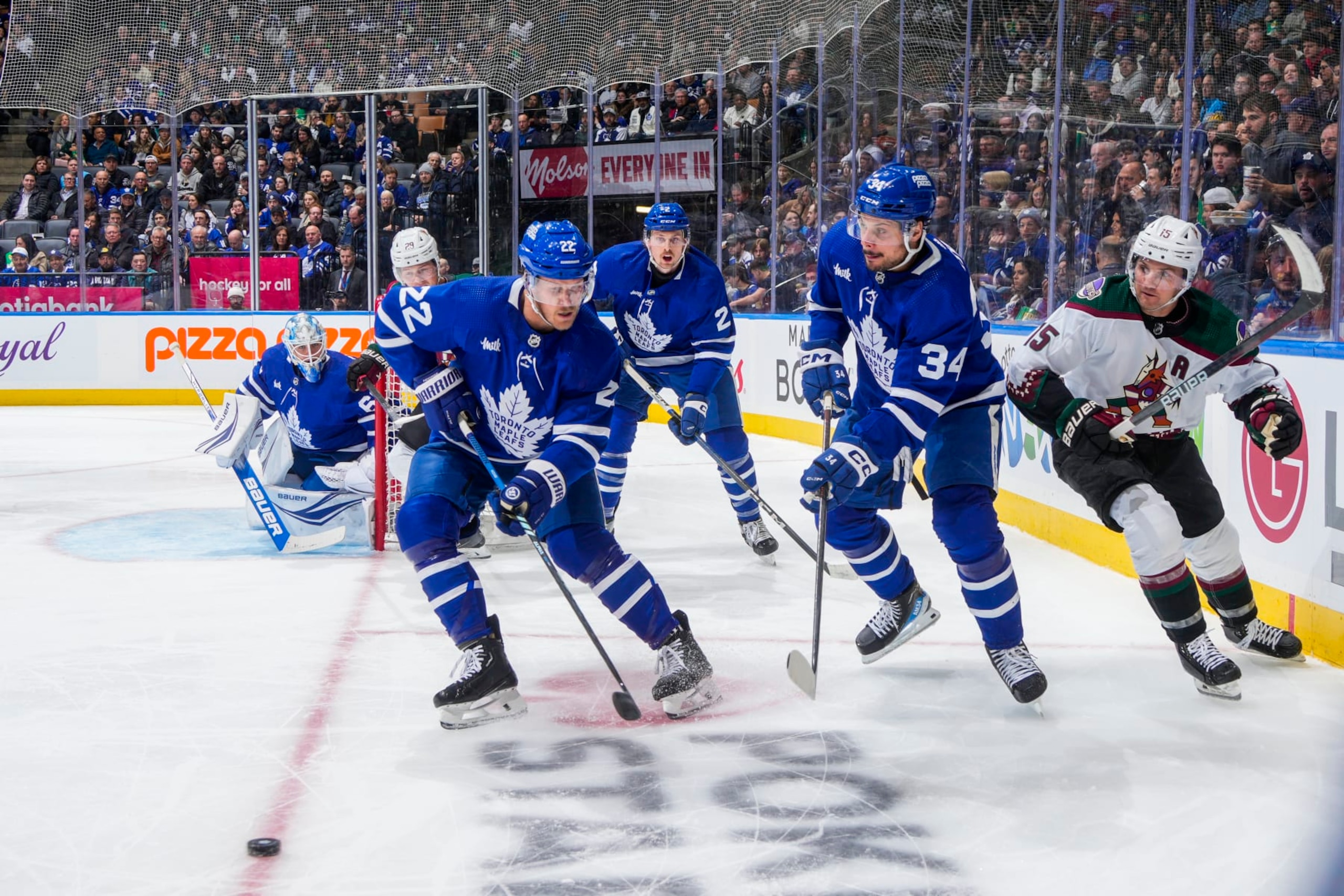 TORONTO, ON - FEBRUARY 29: Auston Matthews #34 of the Toronto Maple Leafs clears the puck against Alex Kerfoot #15 of the Arizona Coyotes during the second period at Scotiabank Arena on February 29, 2024 in Toronto, Ontario, Canada. (Photo by Mark Blinch/NHLI via Getty Images)