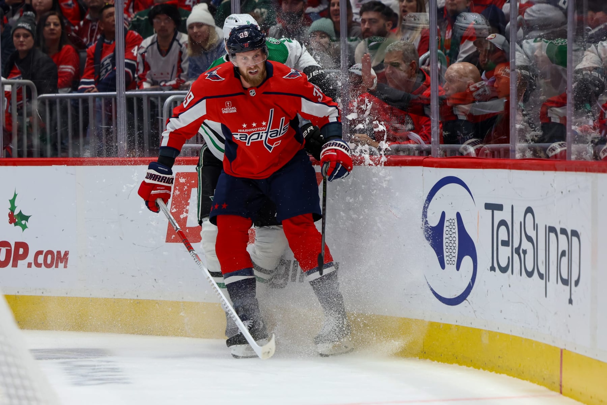 WASHINGTON, DC - DECEMBER 7: Anthony Mantha #39 of the Washington Capitals collides with Jani Hakanpaa #2 of the Dallas Stars during a game at Capital One Arena on December 7, 2023 in Washington, D.C. (Photo by John McCreary/NHLI via Getty Images)