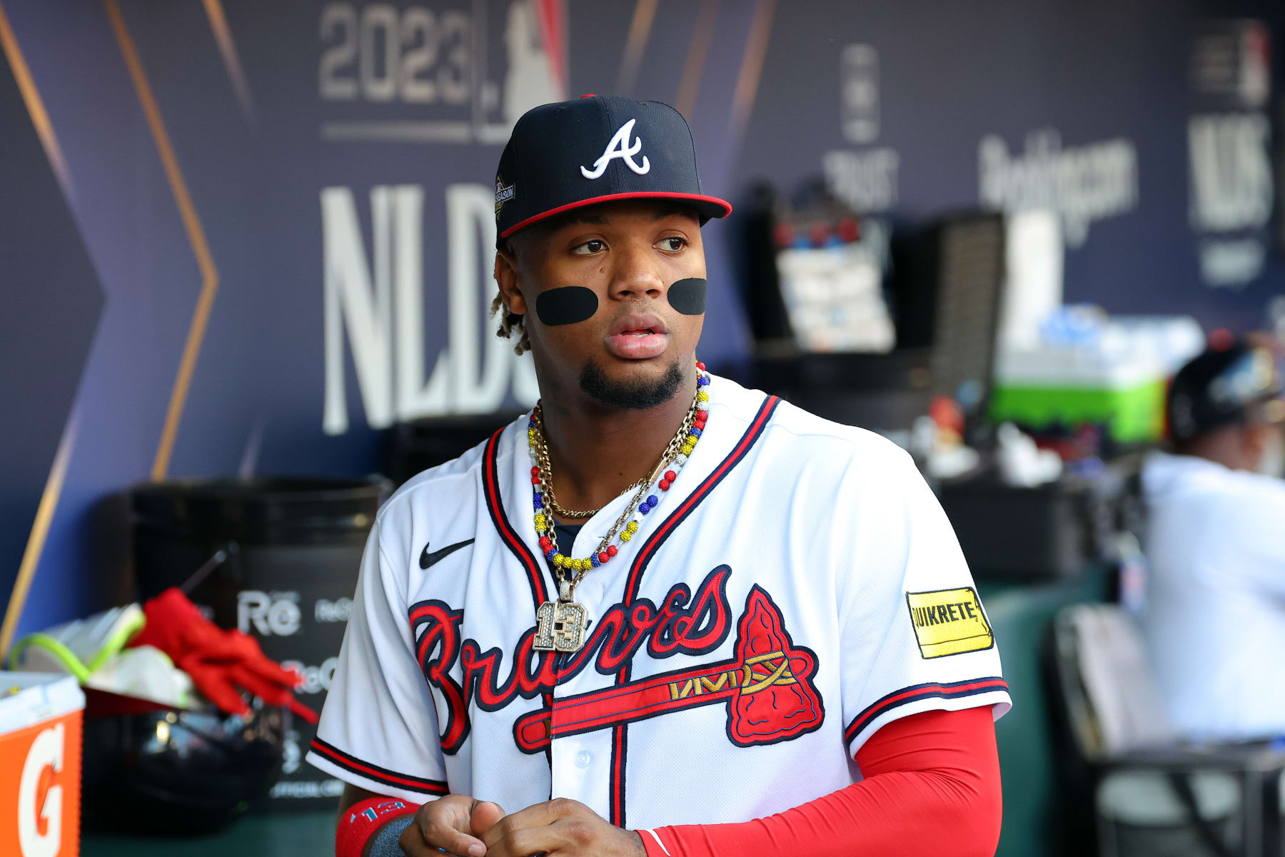 ATLANTA, GEORGIA - OCTOBER 09: Ronald Acuna Jr. #13 of the Atlanta Braves looks on from the dugout prior to Game Two of the Division Series against the Philadelphia Phillies at Truist Park on October 09, 2023 in Atlanta, Georgia. (Photo by Kevin C. Cox/Getty Images)