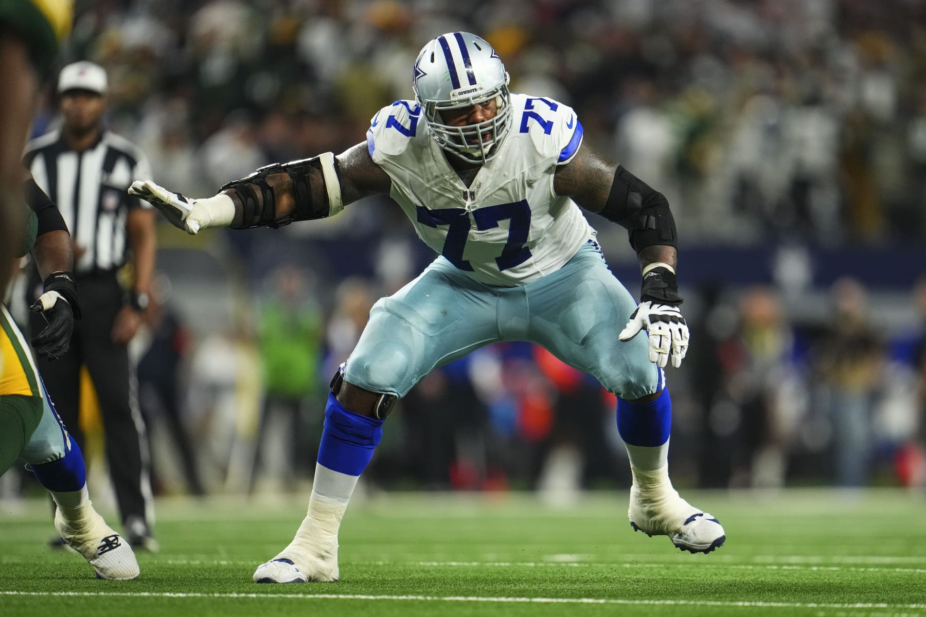 DALLAS, TX - JANUARY 14: Tyron Smith #77 of the Dallas Cowboys drops back to block during an NFL wild-card playoff football game against the Green Bay Packers at AT&T Stadium on January 14, 2024 in Dallas, Texas. (Photo by Cooper Neill/Getty Images)
