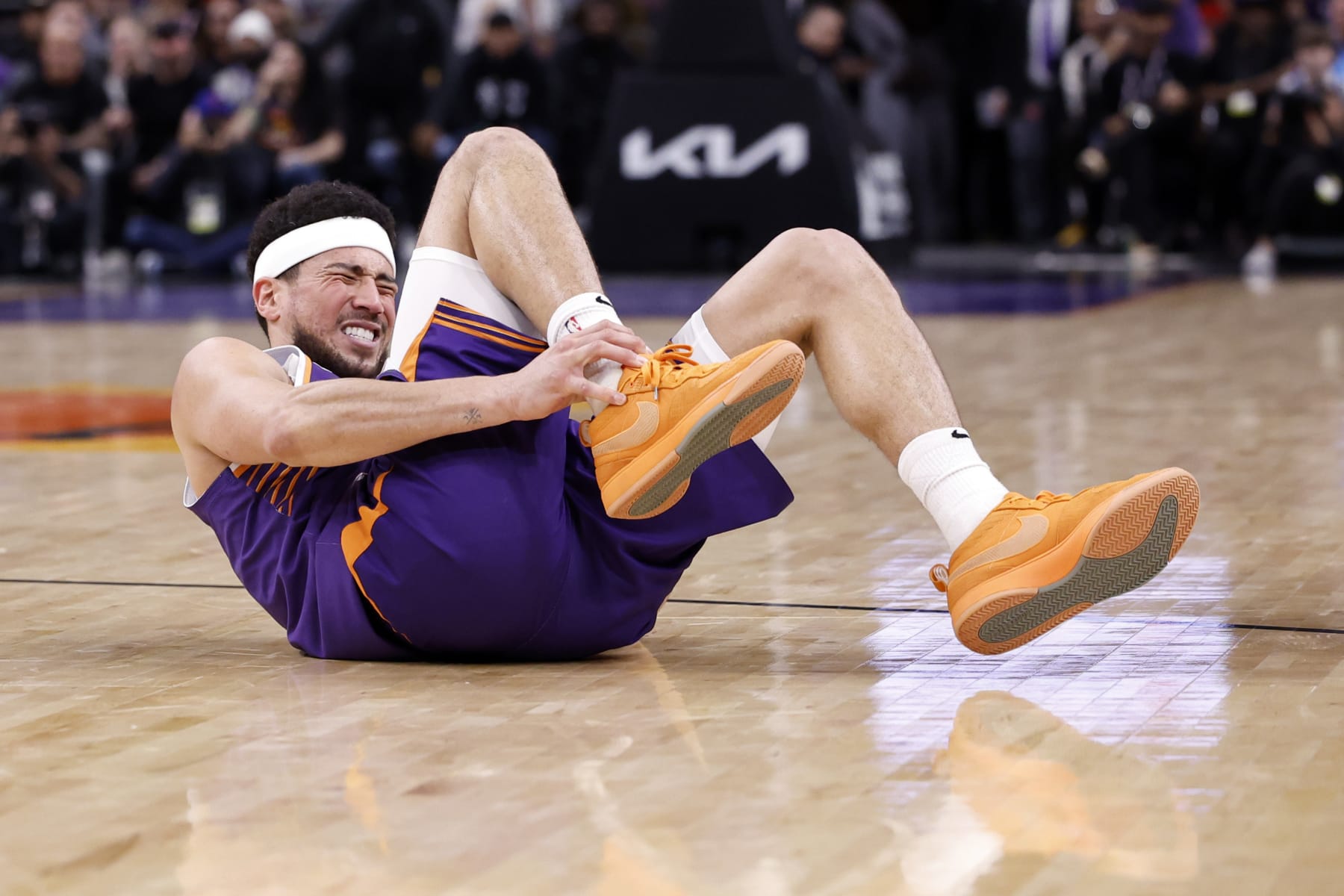 PHOENIX, ARIZONA - MARCH 02: Devin Booker #1 of the Phoenix Suns reacts after an apparent injury during the fourth quarter against the Houston Rockets at Footprint Center on March 02, 2024 in Phoenix, Arizona. NOTE TO USER: User expressly acknowledges and agrees that, by downloading and or using this photograph, User is consenting to the terms and conditions of the Getty Images License Agreement.  (Photo by Chris Coduto/Getty Images)