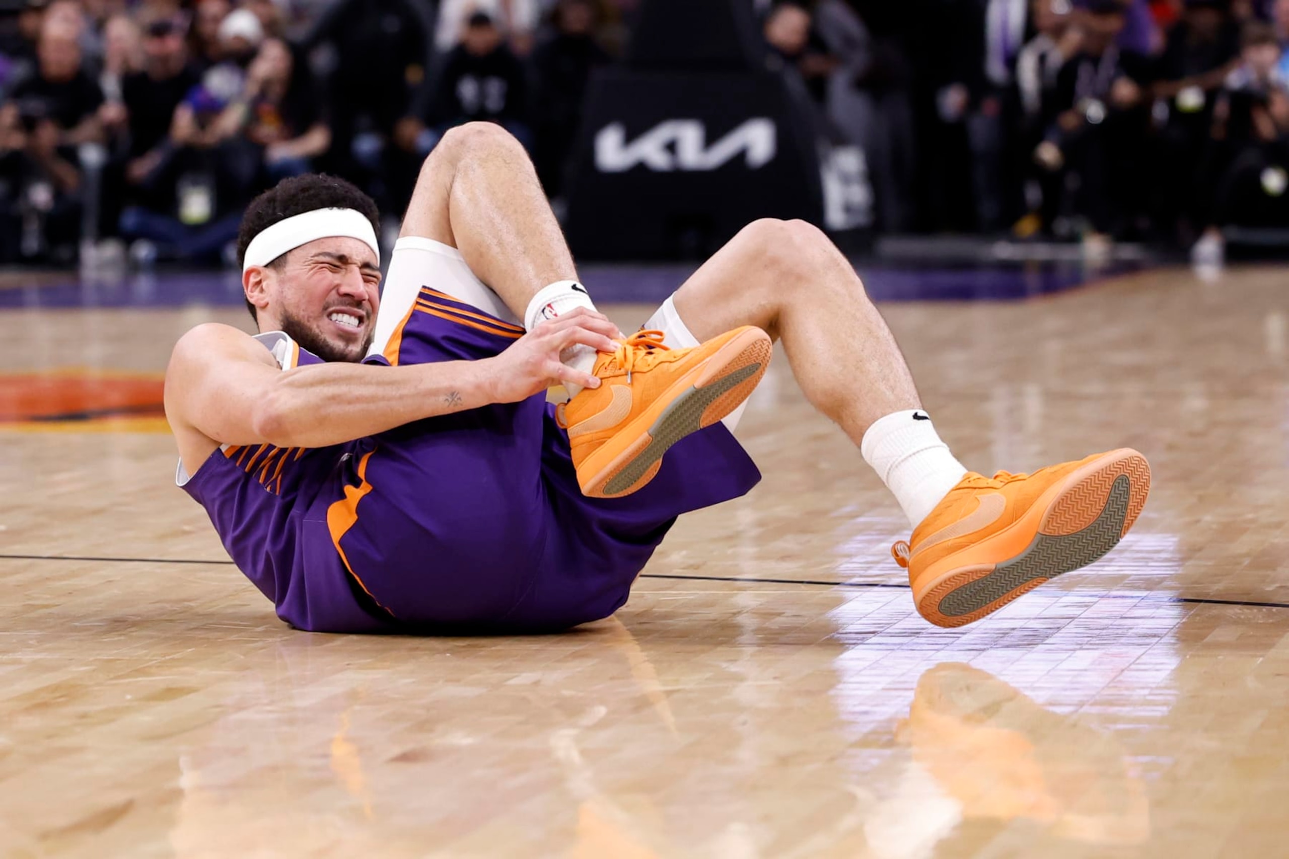 PHOENIX, ARIZONA - MARCH 02: Devin Booker #1 of the Phoenix Suns reacts after an apparent injury during the fourth quarter against the Houston Rockets at Footprint Center on March 02, 2024 in Phoenix, Arizona. NOTE TO USER: User expressly acknowledges and agrees that, by downloading and or using this photograph, User is consenting to the terms and conditions of the Getty Images License Agreement.  (Photo by Chris Coduto/Getty Images)