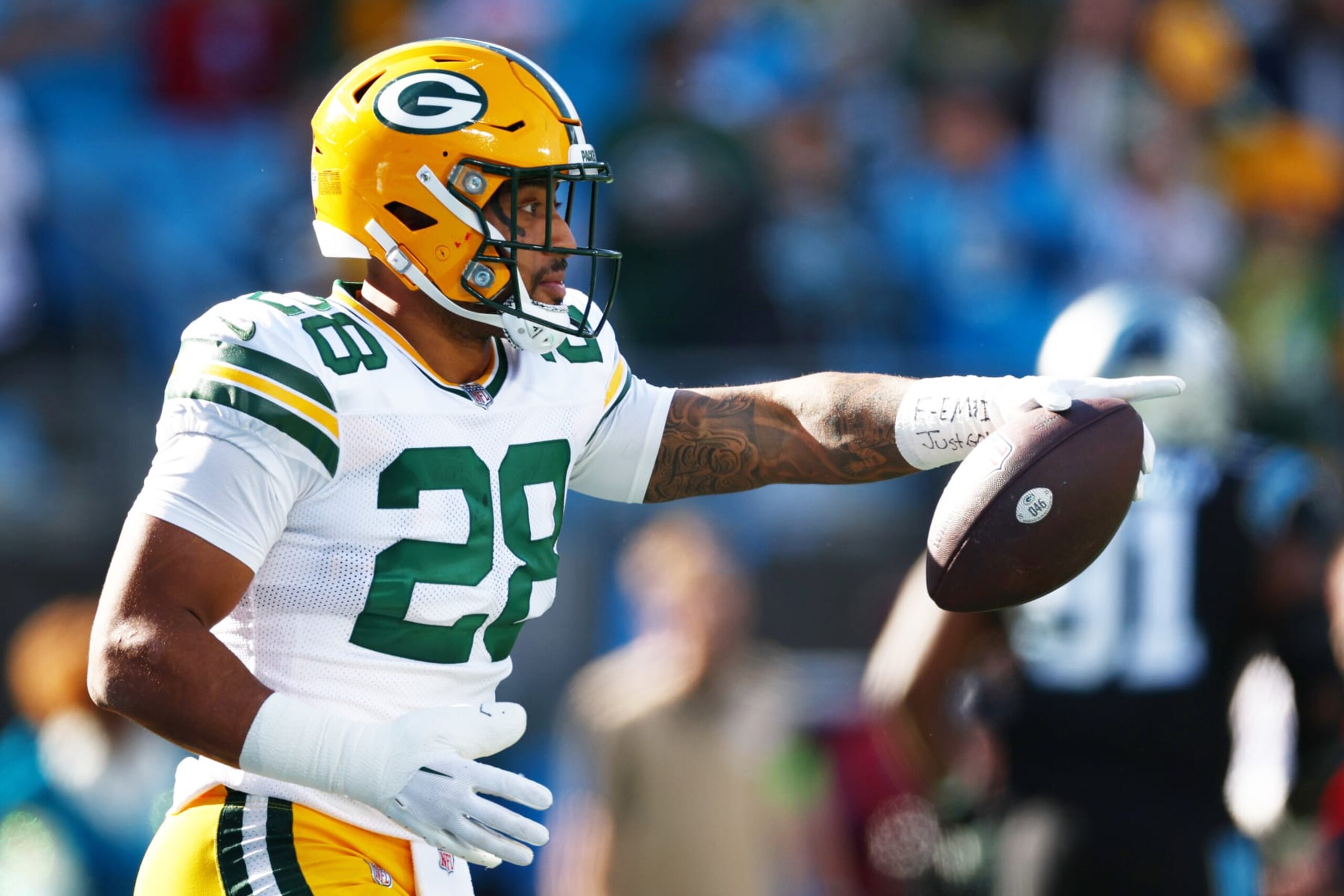 CHARLOTTE, NORTH CAROLINA - DECEMBER 24: AJ Dillon #28 of the Green Bay Packers celebrates after scoring a rushing touchdown during the first quarter against the Carolina Panthers at Bank of America Stadium on December 24, 2023 in Charlotte, North Carolina. (Photo by Jared C. Tilton/Getty Images)