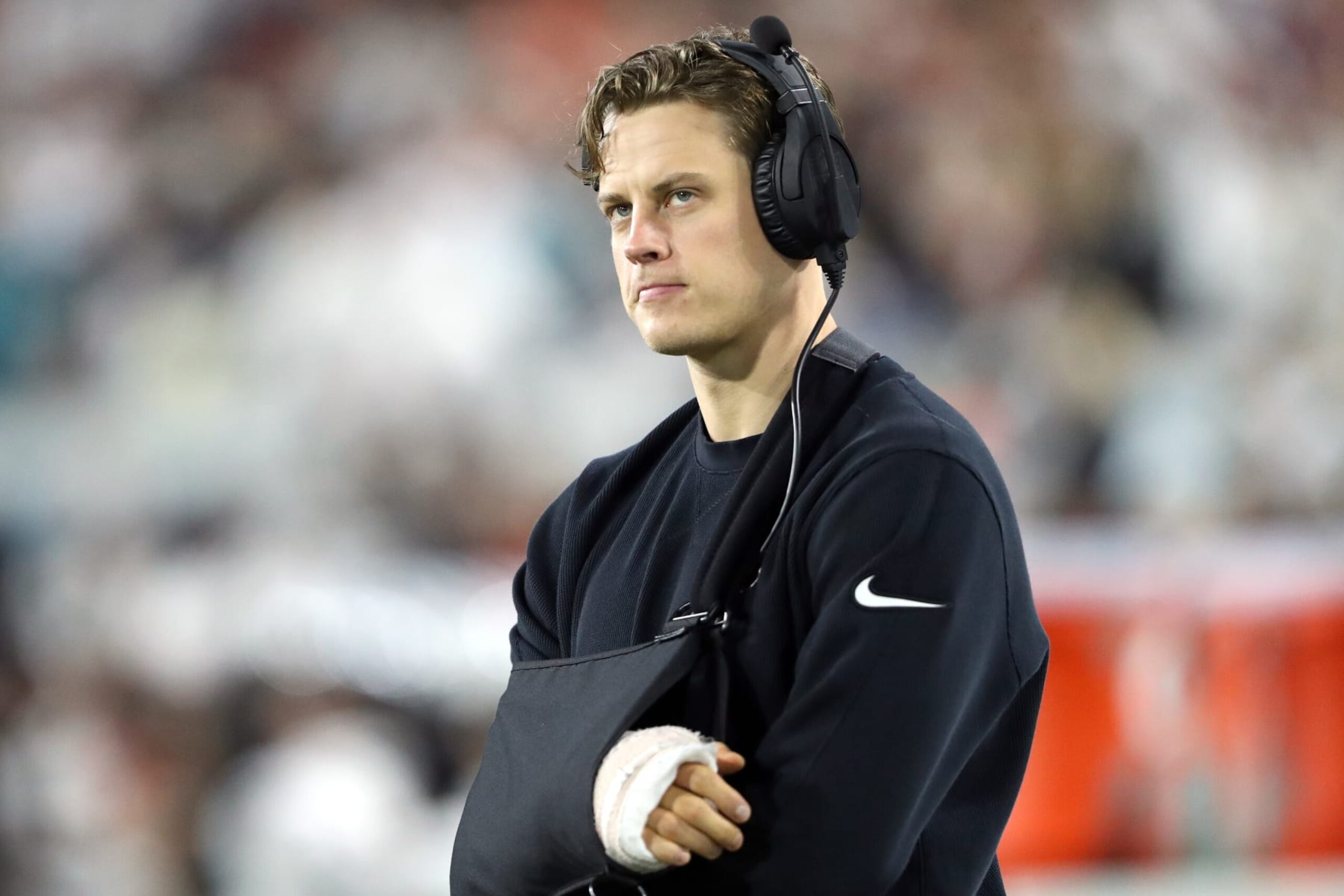 JACKSONVILLE, FLORIDA - DECEMBER 04: Joe Burrow #9 of the Cincinnati Bengals looks on from the sideline during the second half of a game against the Jacksonville Jaguars at EverBank Stadium on December 04, 2023 in Jacksonville, Florida. (Photo by Courtney Culbreath/Getty Images)