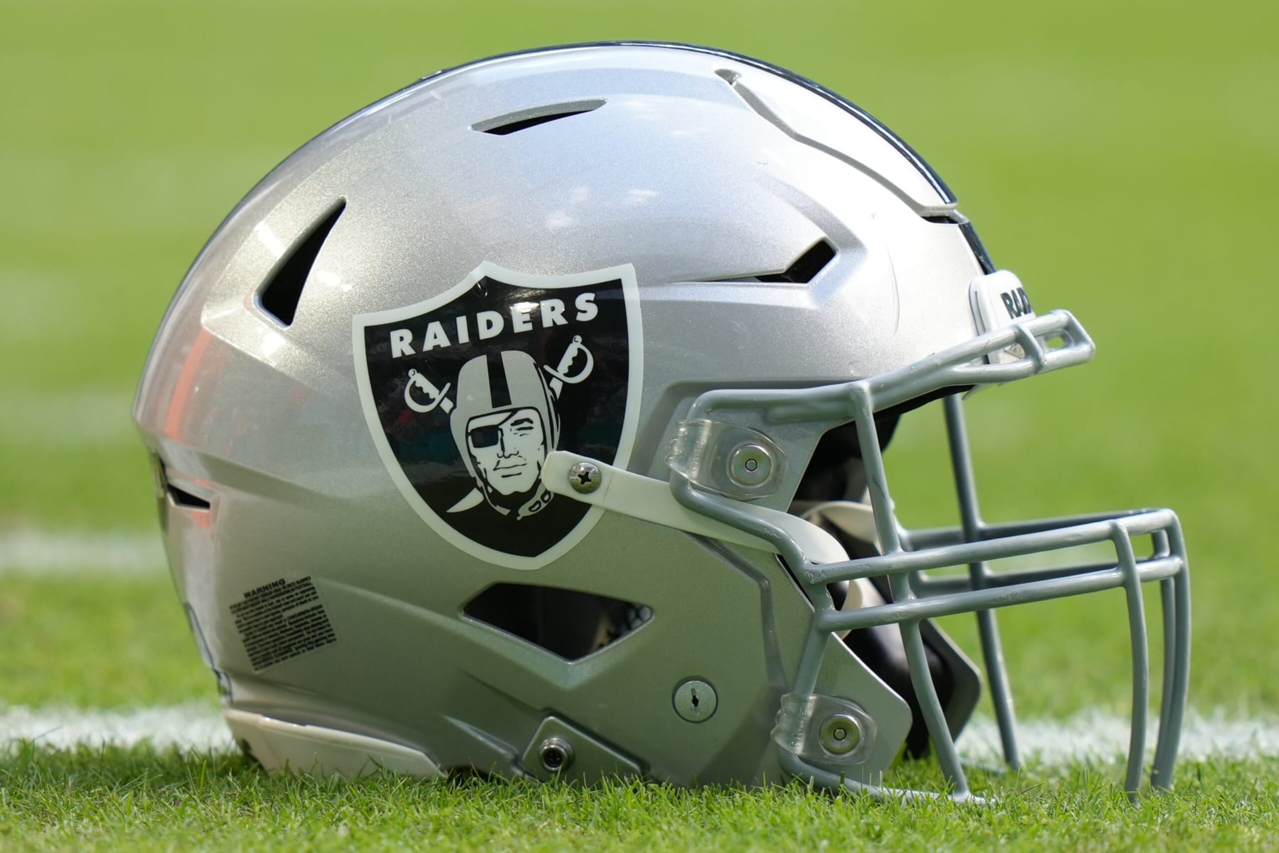 MIAMI GARDENS, FL - NOVEMBER 19: a Las Vegas Raiders helmet rests on the field before the game between the Las Vegas Raiders and the Miami Dolphins on Sunday, November 19, 2023 at Hard Rock Stadium, Miami, Fla. (Photo by Peter Joneleit/Icon Sportswire via Getty Images)