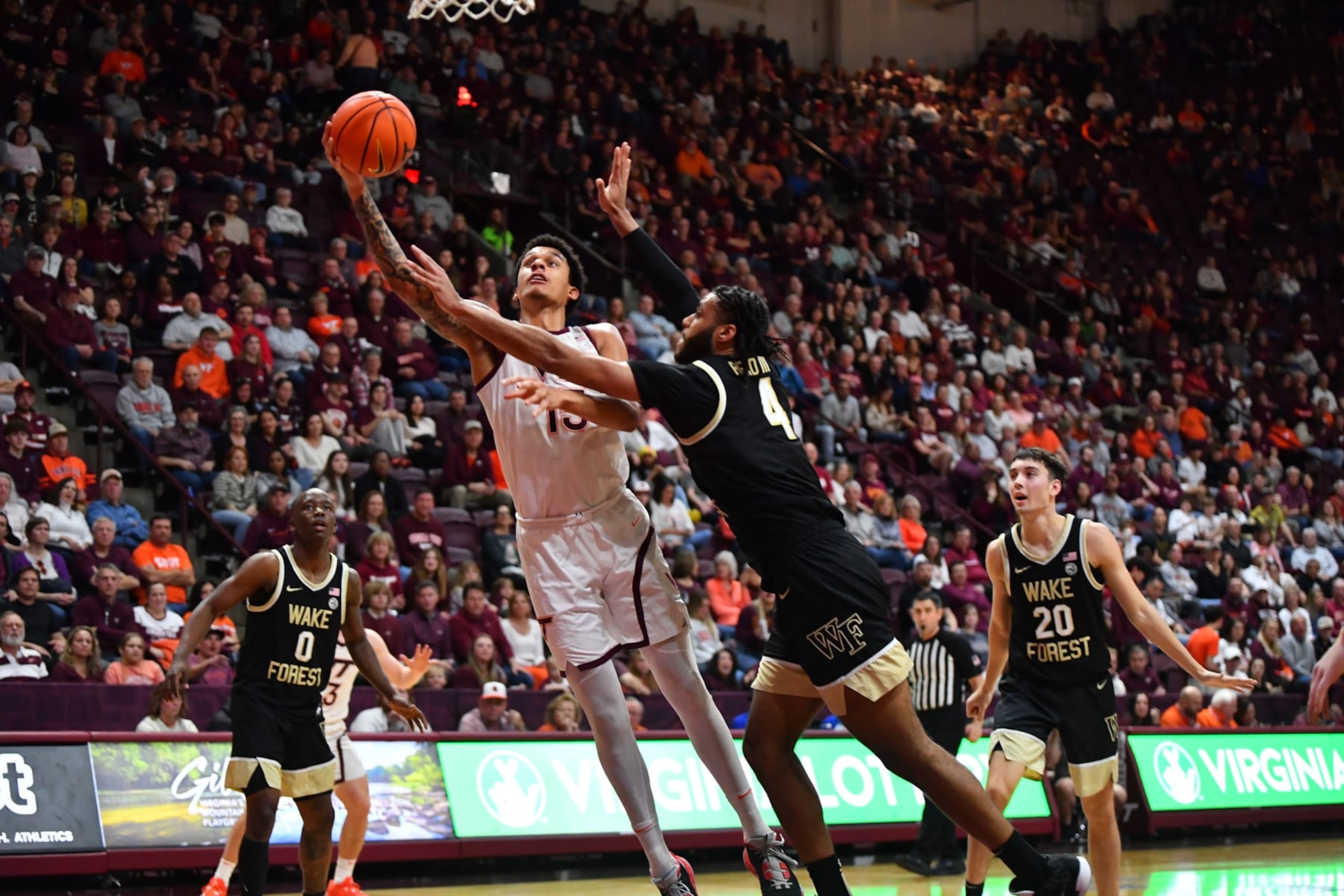 BLACKSBURG, VA - MARCH 02: Virginia Tech Hokies center Lynn Kidd (15) makes a move toward the basket while being defended by Wake Forest Demon Deacons forward Efton Reid III (4) during a college basketball game between the Wake Forest Demon Deacons and the Virginia Tech Hokies on March 02, 2024 at Cassell Coliseum in Blacksburg, VA.  (Photo by Brian Bishop/Icon Sportswire via Getty Images)