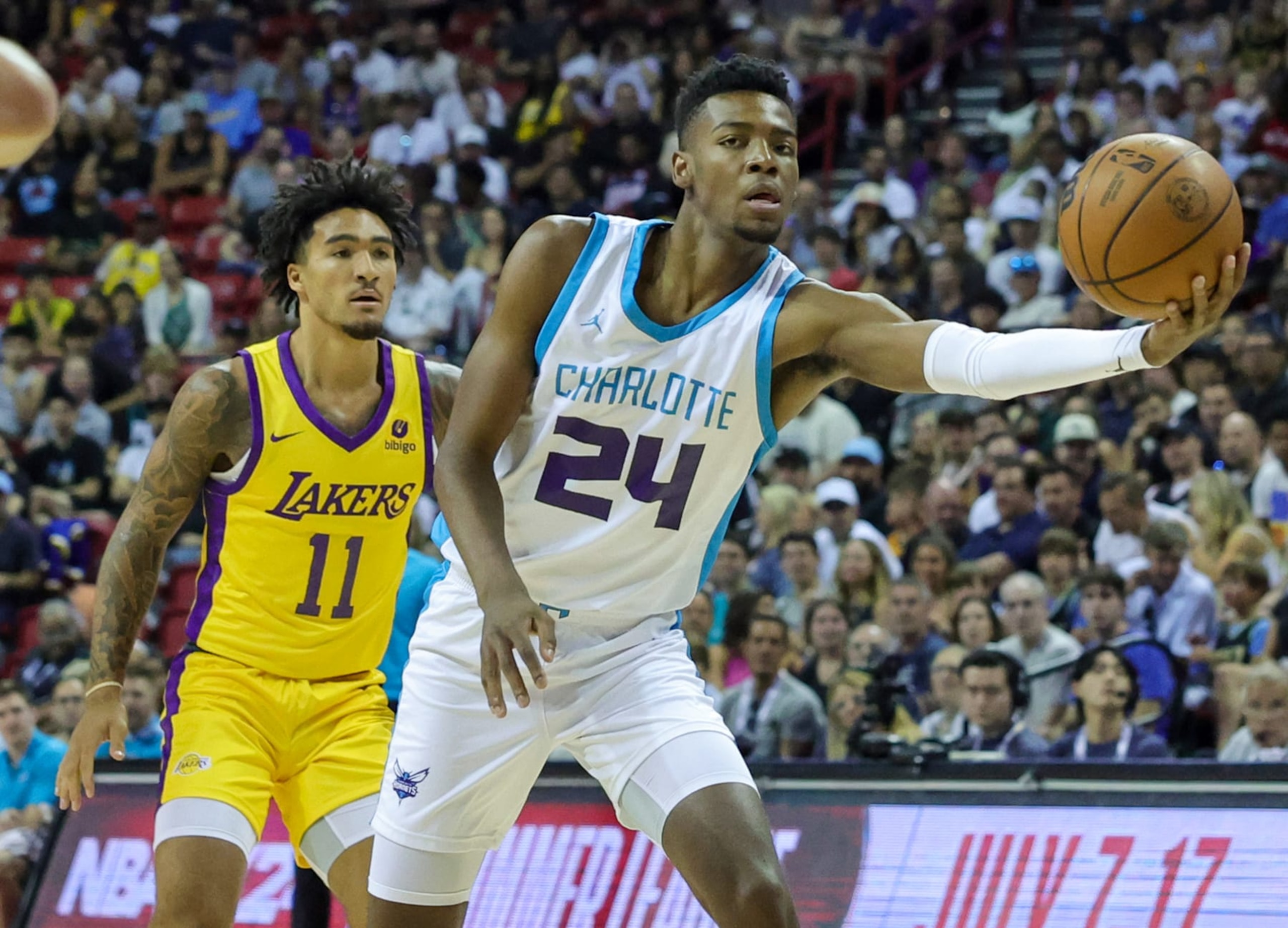 LAS VEGAS, NEVADA - JULY 09: Brandon Miller #24 of the Charlotte Hornets reaches for a pass ahead of Jalen Hood-Schifino #11 of the Los Angeles Lakers in the first half of a 2023 NBA Summer League game at the Thomas & Mack Center on July 09, 2023 in Las Vegas, Nevada. NOTE TO USER: User expressly acknowledges and agrees that, by downloading and or using this photograph, User is consenting to the terms and conditions of the Getty Images License Agreement. (Photo by Ethan Miller/Getty Images)