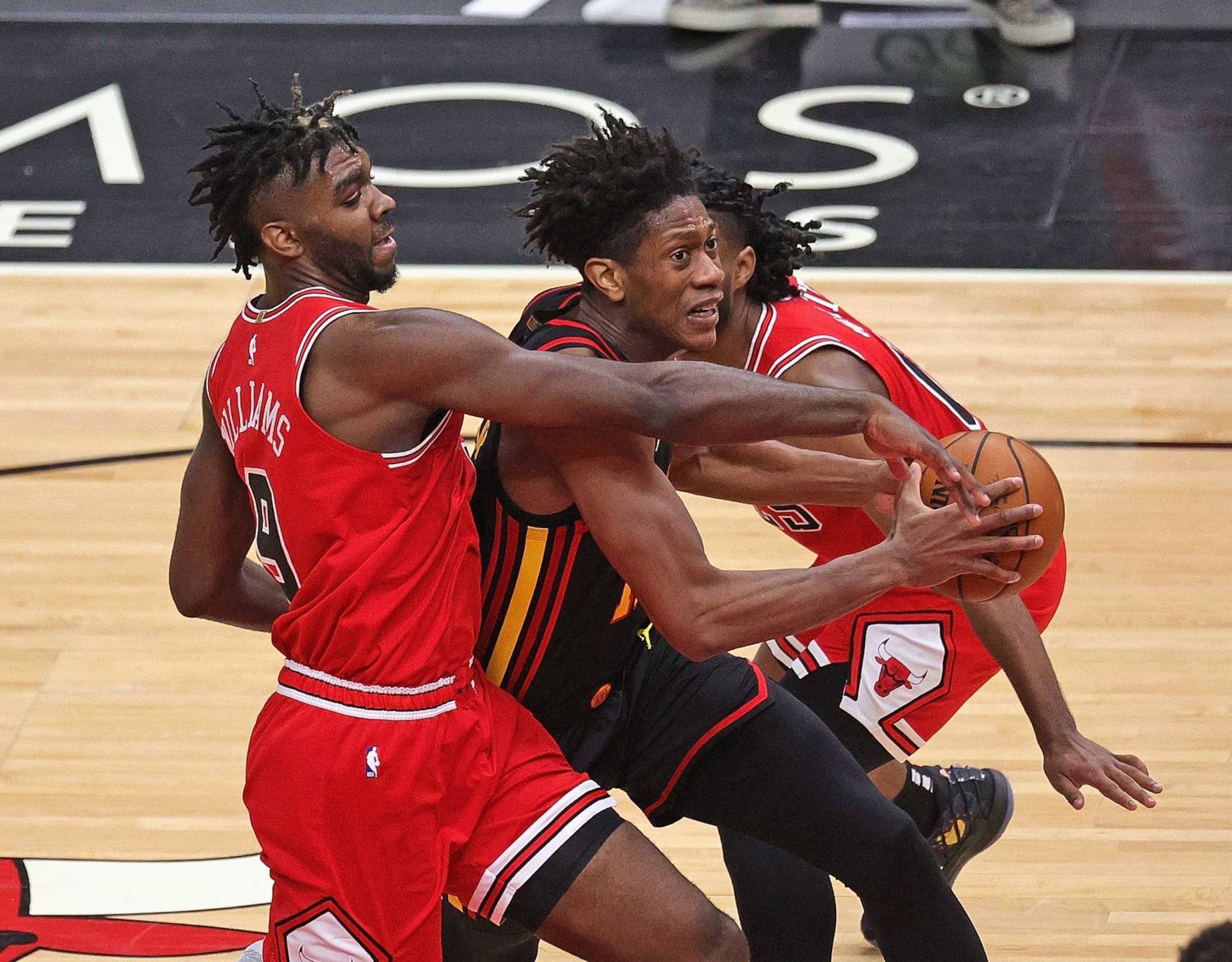CHICAGO, ILLINOIS - DECEMBER 23: Patrick Williams #9 of the Chicago Bulls tries to defend against De'Andre Hunter #12 of the Atlanta Hawks at the United Center on December 23, 2020 in Chicago, Illinois.  NOTE TO USER: User expressly acknowledges and agrees that, by downloading and or using this photograph, User is consenting to the terms and conditions of the Getty Images License Agreement. (Photo by Jonathan Daniel/Getty Images)