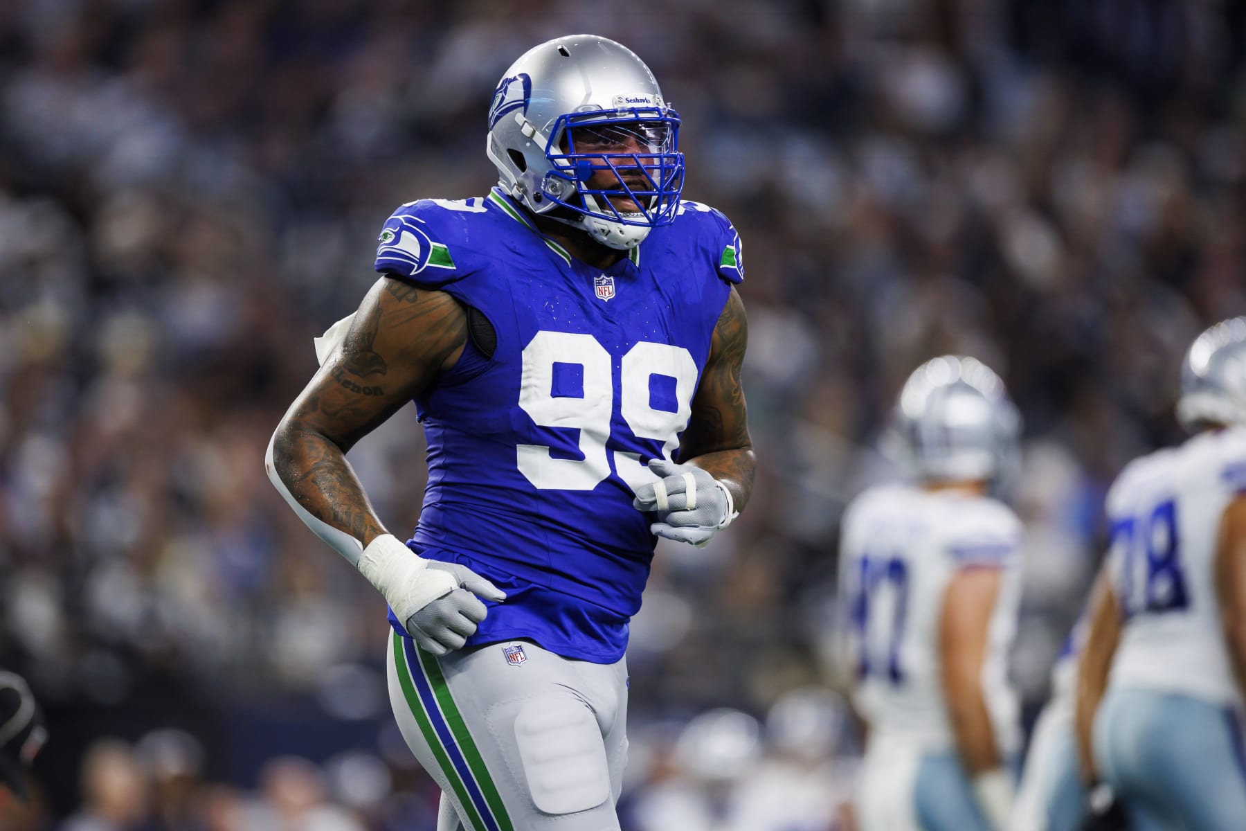 ARLINGTON, TEXAS - NOVEMBER 30: Leonard Williams #99 of the Seattle Seahawks runs during an NFL football game against the Dallas Cowboys at AT&T Stadium on November 30, 2023 in Arlington, Texas. (Photo by Ryan Kang/Getty Images)