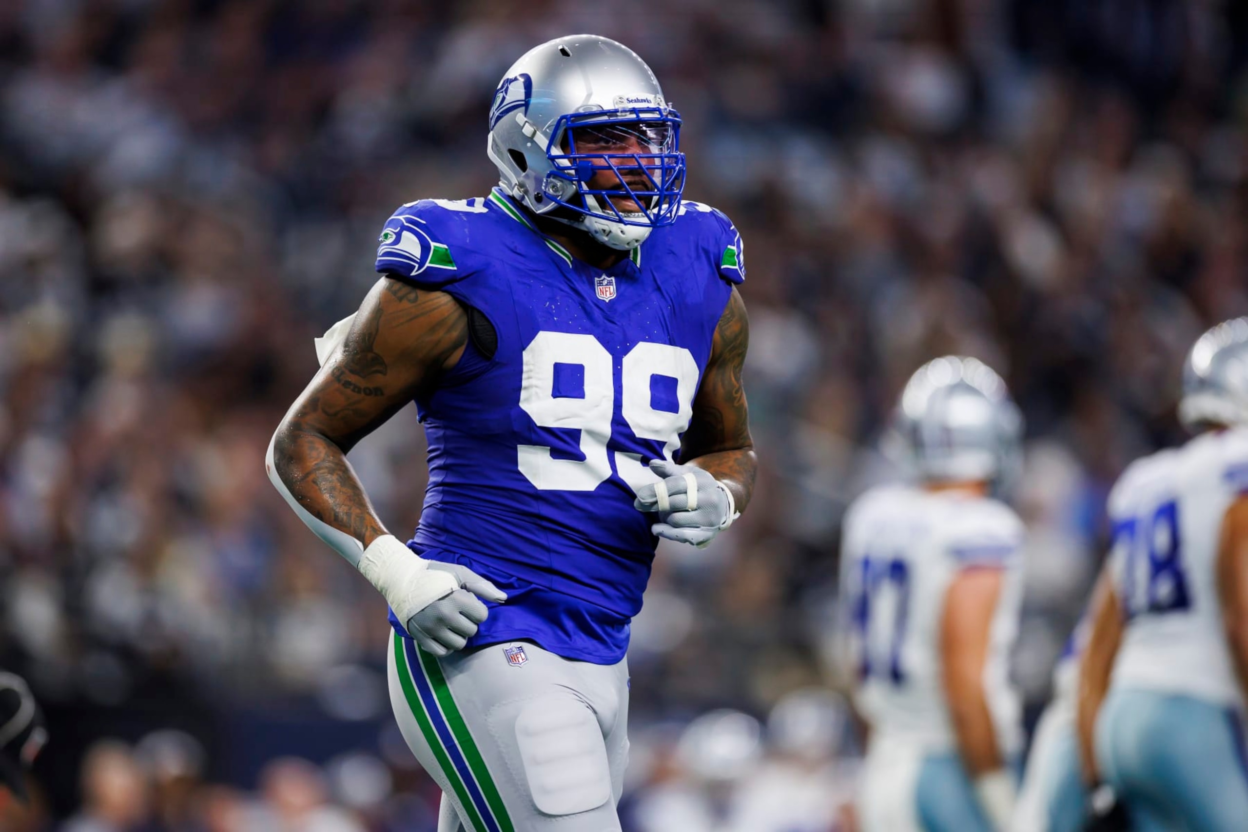 ARLINGTON, TEXAS - NOVEMBER 30: Leonard Williams #99 of the Seattle Seahawks runs during an NFL football game against the Dallas Cowboys at AT&T Stadium on November 30, 2023 in Arlington, Texas. (Photo by Ryan Kang/Getty Images)