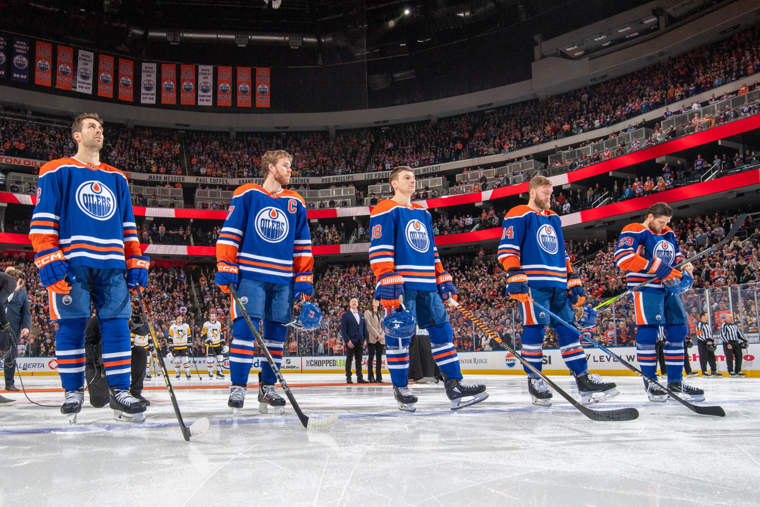 EDMONTON, CANADA - MARCH 3: Evan Bouchard #2, Connor McDavid #97, Zach Hyman #18, Mattias Ekholm #14 and Leon Draisaitl #29 of the Edmonton Oilers stand for the playing of the national anthem before the game against the Pittsburgh Penguins at Rogers Place on March 03, 2024, in Edmonton, Alberta, Canada. (Photo by Andy Devlin/NHLI via Getty Images) EDMONTON, CANADA - MARCH 3: Evan Bouchard #2, Connor McDavid #97, Zach Hyman #18, Mattias Ekholm #14 and Leon Draisaitl #29 of the Edmonton Oilers stand for the playing of the national anthem before the game against the Pittsburgh Penguins at Rogers Place on March 03, 2024, in Edmonton, Alberta, Canada. (Photo by Andy Devlin/NHLI via Getty Images)