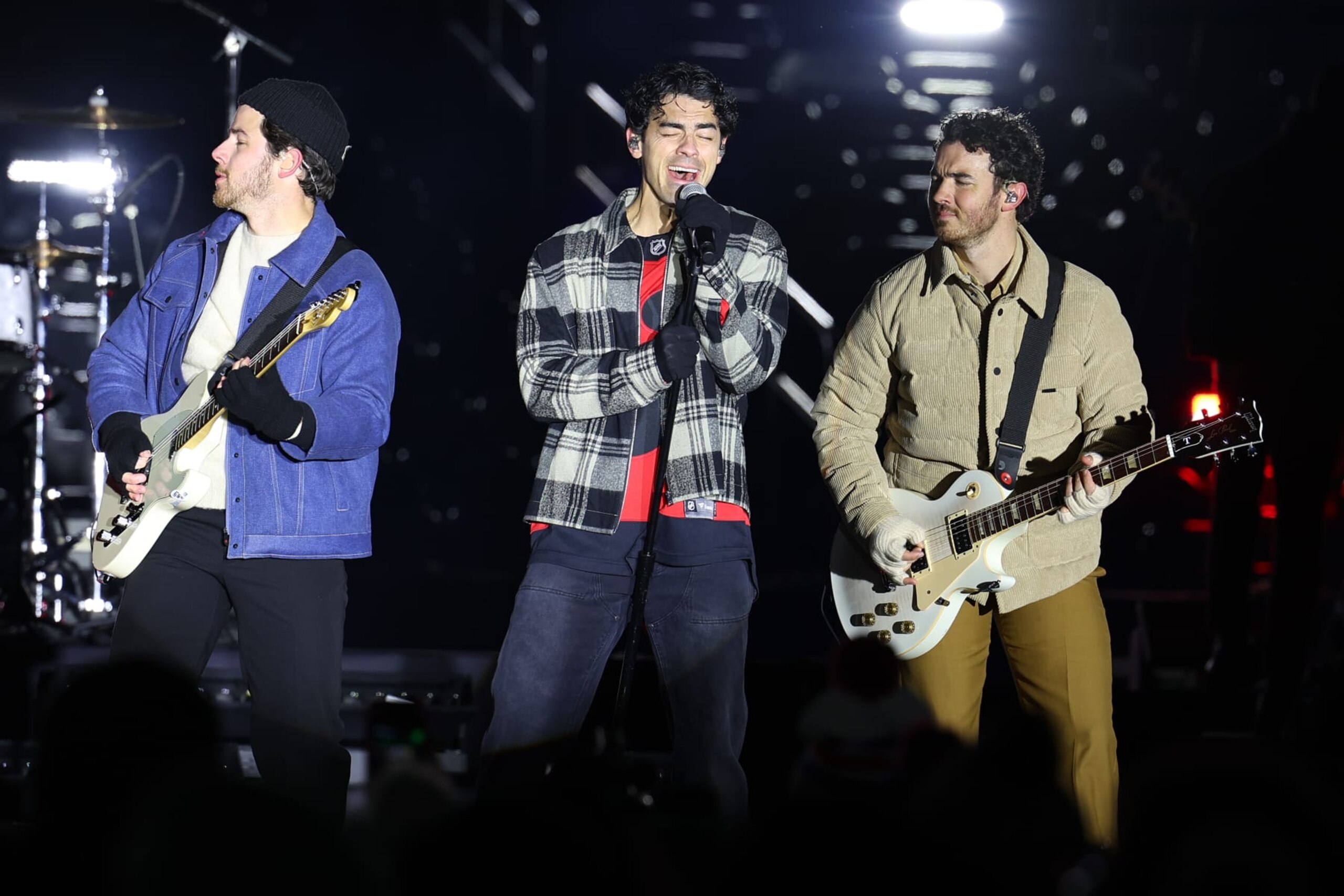 EAST RUTHERFORD, NJ - FEBRUARY 17: Nick, Joe and Kevin Jonas perform during a pre-game concert  prior to the 2024 Navy Federal Credit Union Stadium Series game at MetLife Stadium on February 17, 2024 in East Rutherford, New Jersey.  (Photo by Rich Graessle/NHLI via Getty Images)