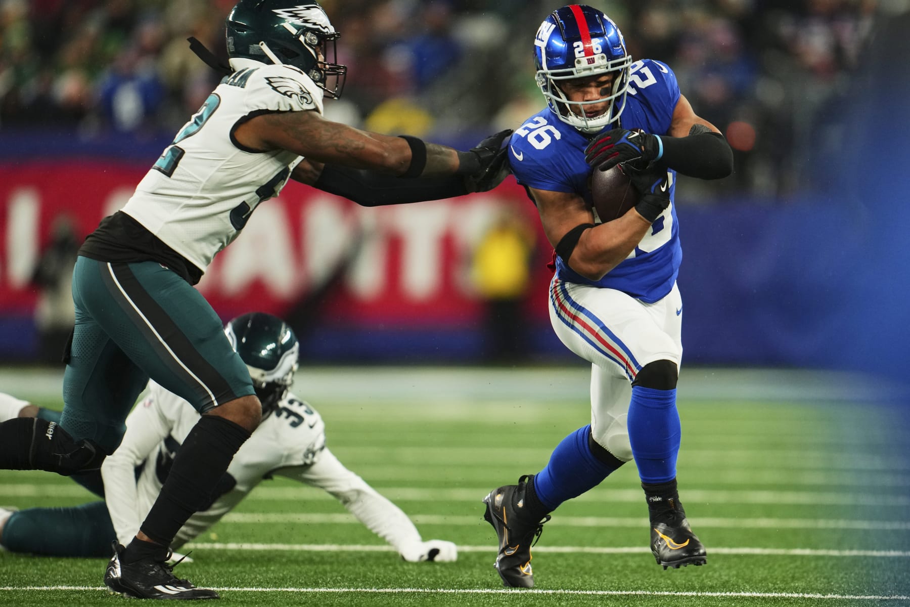 EAST RUTHERFORD, NJ - JANUARY 07: Saquon Barkley #26 of the New York Giants runs with the ball against the Philadelphia Eagles during the first half at MetLife Stadium on January 7, 2024 in East Rutherford, New Jersey. (Photo by Cooper Neill/Getty Images)