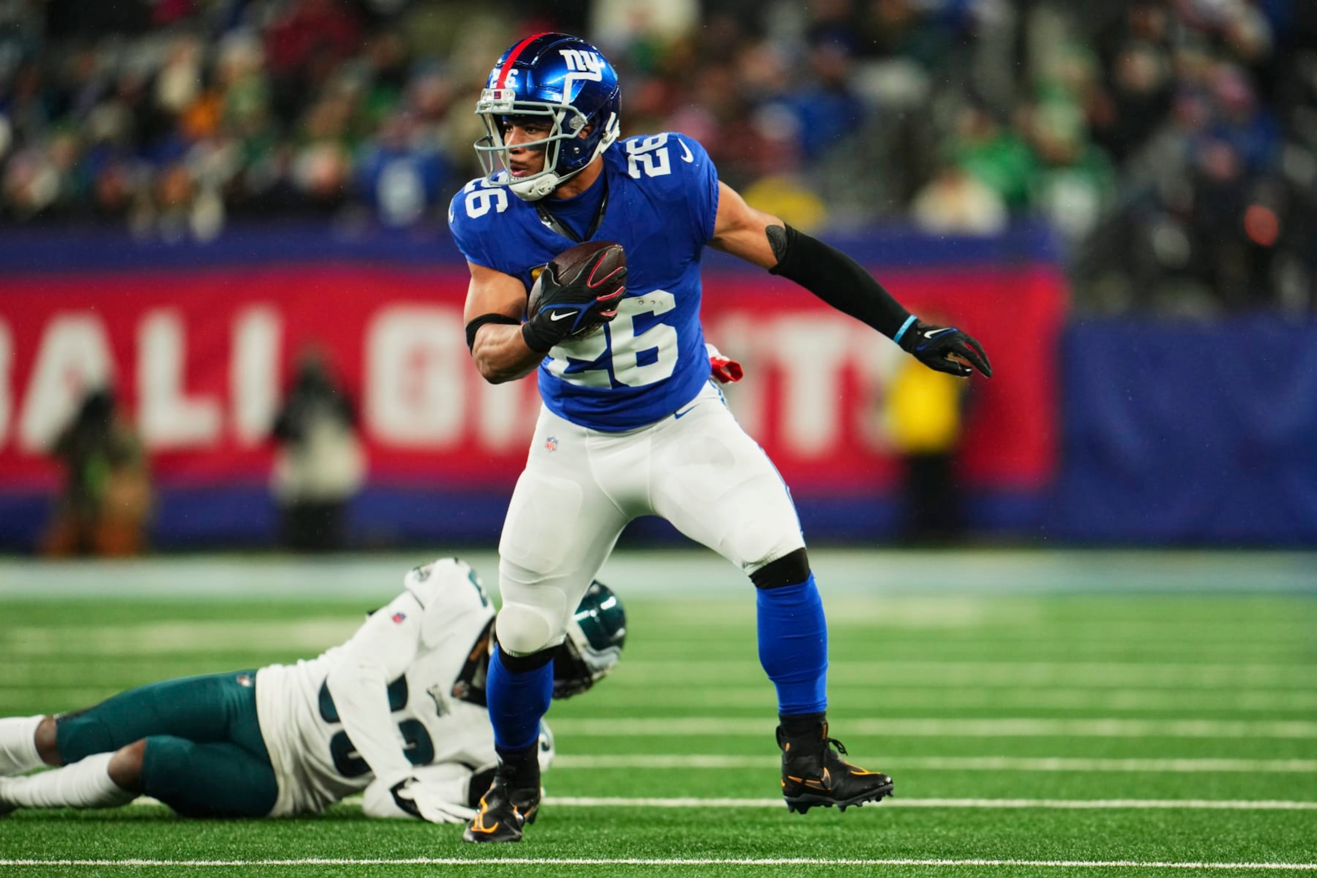 EAST RUTHERFORD, NJ - JANUARY 07: Saquon Barkley #26 of the New York Giants runs with the ball against the Philadelphia Eagles during the first half at MetLife Stadium on January 7, 2024 in East Rutherford, New Jersey. (Photo by Cooper Neill/Getty Images)
