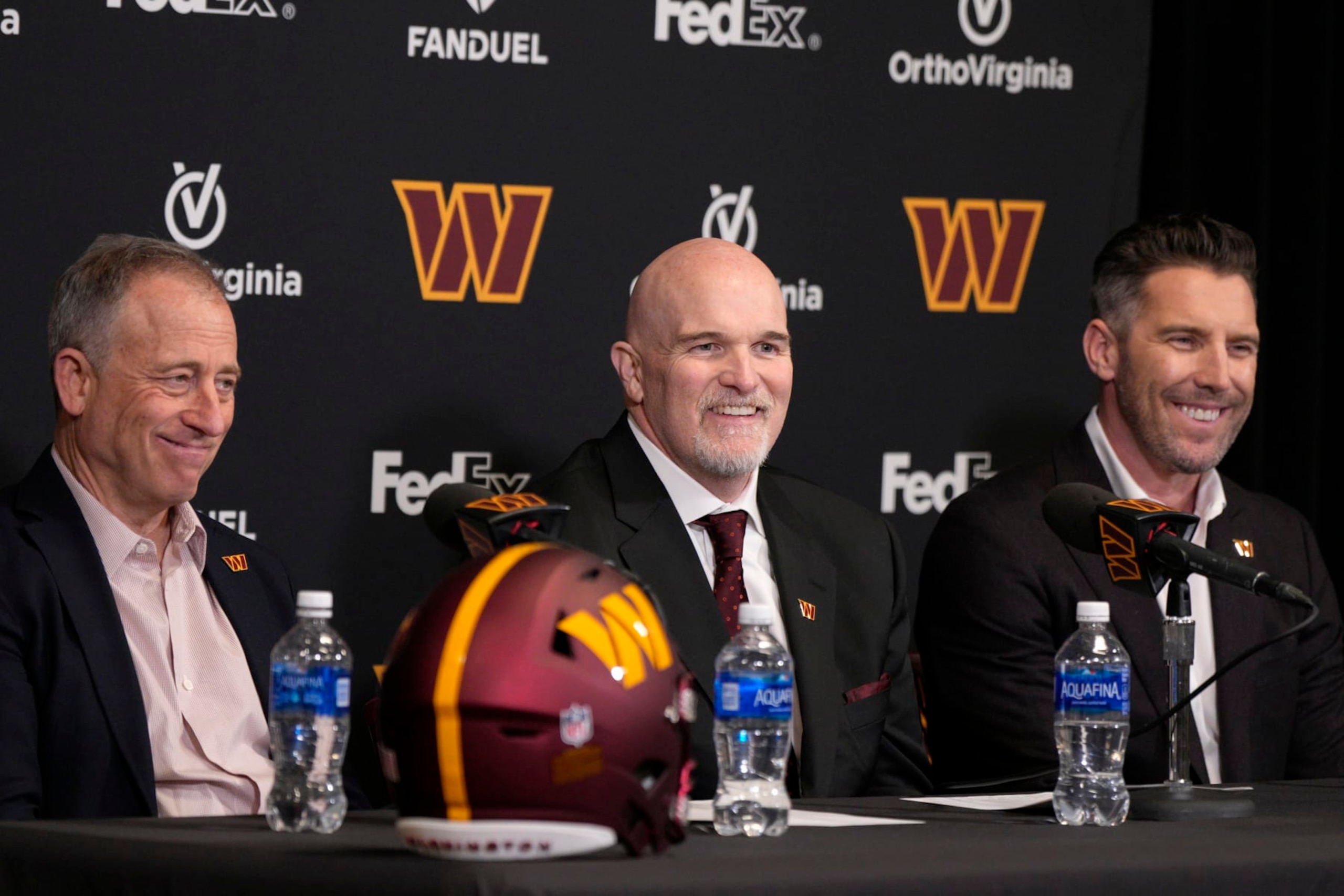 ASHBURN, VIRGINIA - FEBRUARY 05: Head coach Dan Quinn of the Washington Commanders speaks during a press conference alongside managing partner Josh Harris, left, and general manager Adam Peters at OrthoVirginia Training Center at Commanders Park on February 05, 2024 in Ashburn, Virginia. (Photo by Jess Rapfogel/Getty Images) ASHBURN, VIRGINIA - FEBRUARY 05: Head coach Dan Quinn of the Washington Commanders speaks during a press conference alongside managing partner Josh Harris, left, and general manager Adam Peters at OrthoVirginia Training Center at Commanders Park on February 05, 2024 in Ashburn, Virginia. (Photo by Jess Rapfogel/Getty Images)