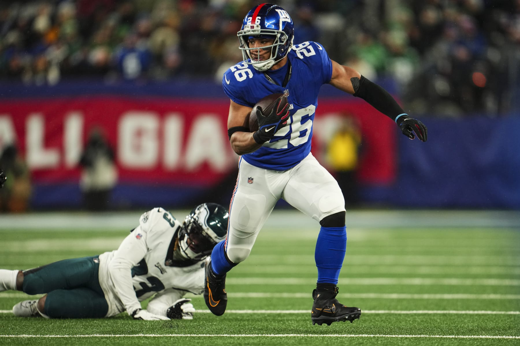 EAST RUTHERFORD, NJ - JANUARY 07: Saquon Barkley #26 of the New York Giants runs the ball during an NFL football game against the Philadelphia Eagles at MetLife Stadium on January 7, 2024 in East Rutherford, New Jersey. (Photo by Cooper Neill/Getty Images)