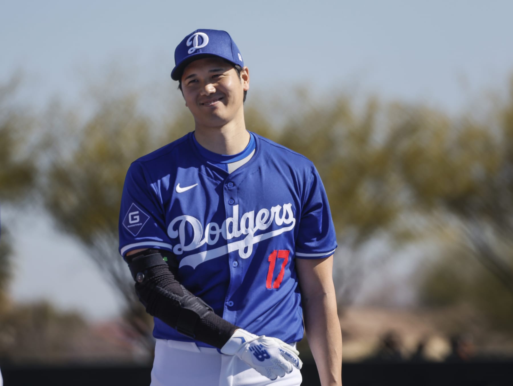 Goodyear, Arizona, Wednesday, February 14, 2024 - Shohei Ohtani warms up near the batting cage before taking some swings during Dodgers spring training.  (Robert Gauthier/Los Angeles Times via Getty Images)