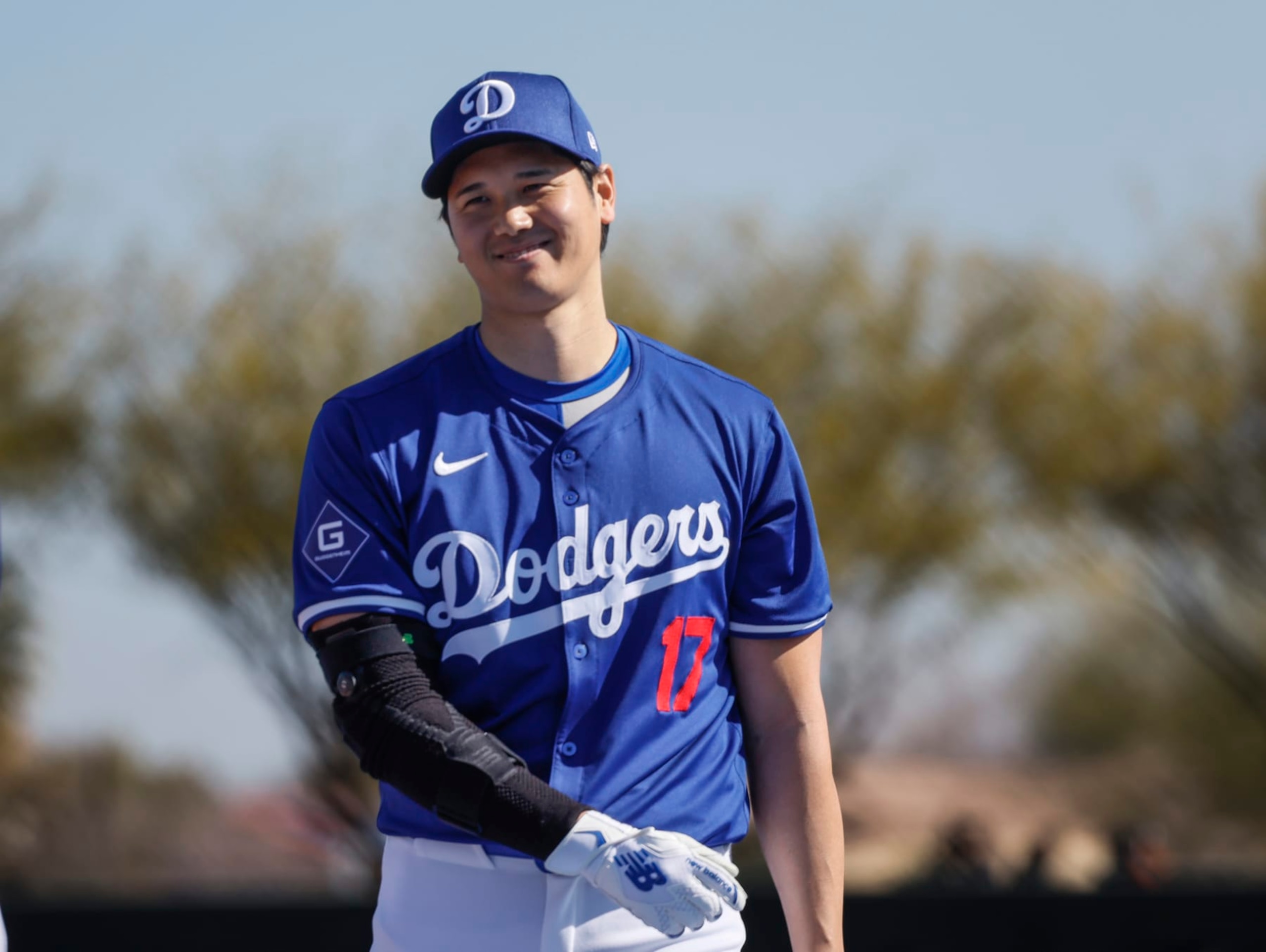 Goodyear, Arizona, Wednesday, February 14, 2024 - Shohei Ohtani warms up near the batting cage before taking some swings during Dodgers spring training.  (Robert Gauthier/Los Angeles Times via Getty Images)