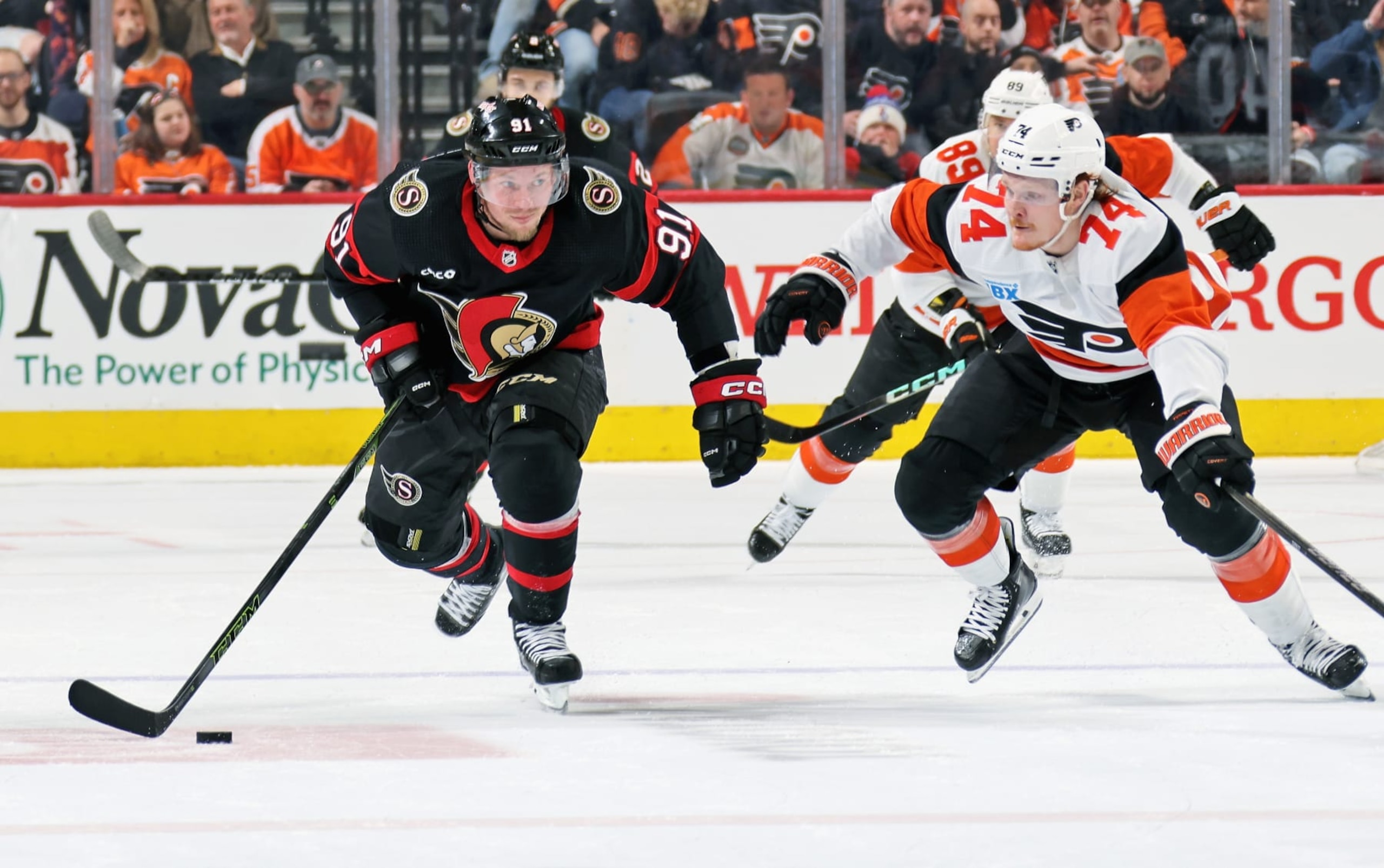 PHILADELPHIA, PENNSYLVANIA - MARCH 02: Vladimir Tarasenko #91 of the Ottawa Senators skates with the puck while being pursued by Owen Tippett #74 of the Philadelphia Flyers at the Wells Fargo Center on March 2, 2024 in Philadelphia, Pennsylvania. The Flyers went on to defeat the Senators 4-2. (Photo by Len Redkoles/NHLI via Getty Images)