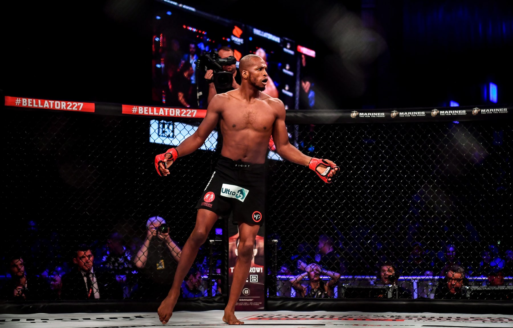 Michael Page celebrates after defeating Richard Kiely in the Bellator cage