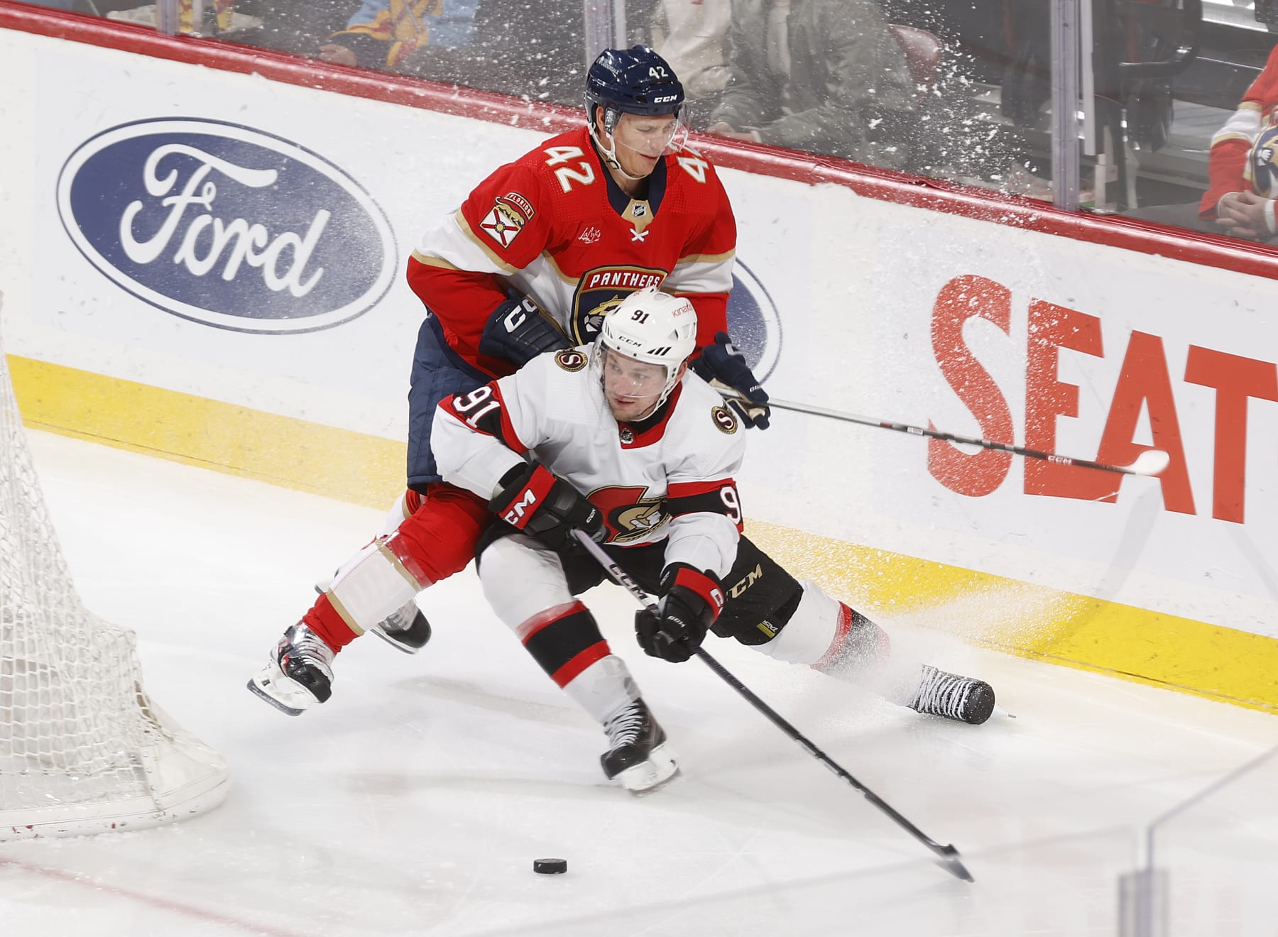SUNRISE, FL - FEBRUARY 20: Gustav Forsling #42 of the Florida Panthers attempts t defend against Vladimir Tarasenko #91 of the Ottawa Senators at the Amerant Bank Arena on February 20, 2024 in Sunrise, Florida. (Photo by Joel Auerbach/Getty Images)