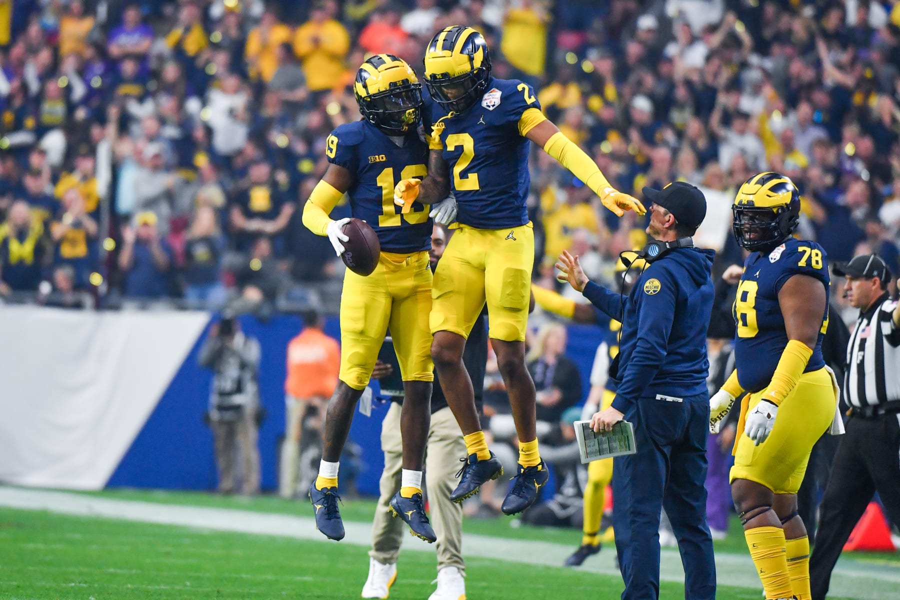GLENDALE, ARIZONA - DECEMBER 31: Rod Moore #19 and Will Johnson #2 of the Michigan Wolverines celebrate after an interception during the first half of a college football playoff semifinal game against the TCU Horned Frogs at State Farm Stadium on December 31, 2022 in Glendale, Arizona. (Photo by Aaron J. Thornton/Getty Images)