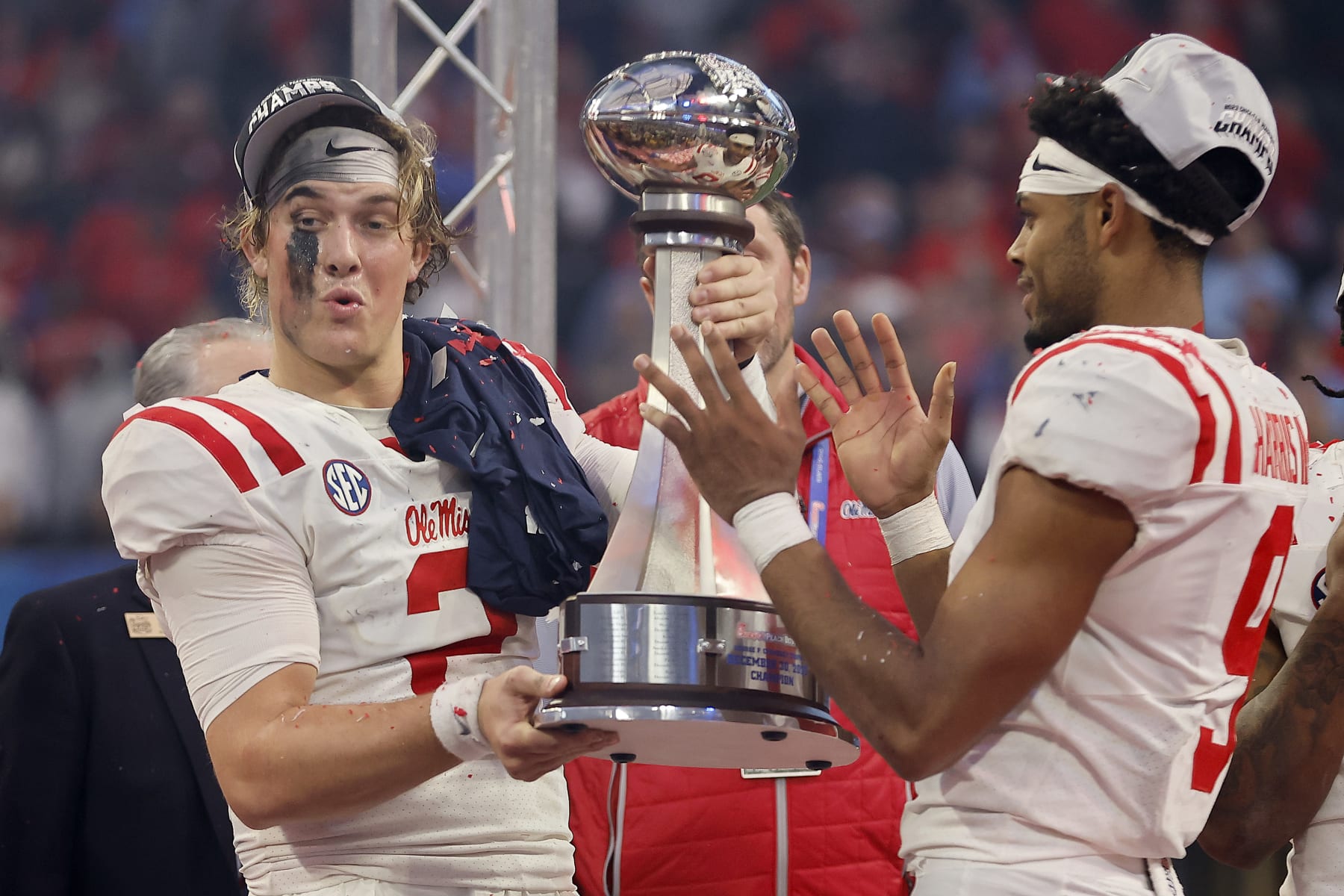 ATLANTA, GEORGIA - DECEMBER 30: Jaxson Dart #2 and Tre Harris #9 of the Mississippi Rebels hoist the George P. Crumbley Trophy after beating Penn State Nittany Lions during the Chick-fil-A Peach Bowl at Mercedes-Benz Stadium on December 30, 2023 in Atlanta, Georgia. (Photo by Alex Slitz/Getty Images)
