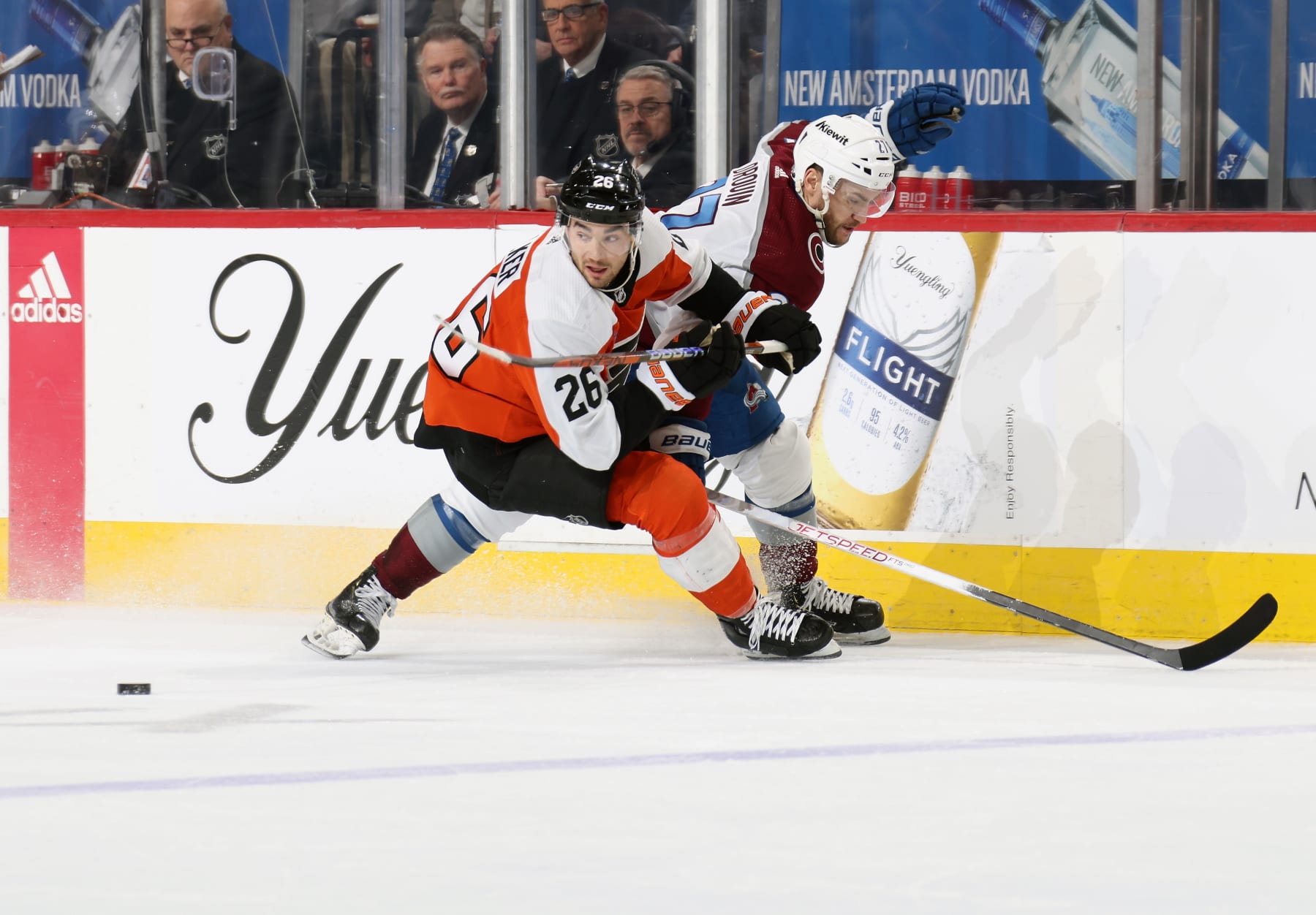 PHILADELPHIA, PENNSYLVANIA - JANUARY 20:  Sean Walker #26 of the Philadelphia Flyers skates after the puck against Jonathan Drouin #27 of the Colorado Avalanche at the Wells Fargo Center on January 20, 2024 in Philadelphia, Pennsylvania.  (Photo by Len Redkoles/NHLI via Getty Images)