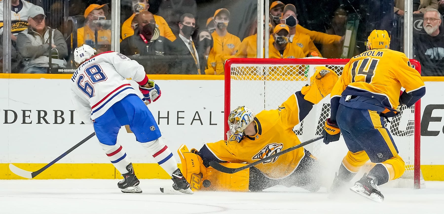 NASHVILLE, TN - DECEMBER 4: Juuse Saros #74 of the Nashville Predators makes the save in overtime against Mike Hoffman #68 of the Montreal Canadiens during an NHL game at Bridgestone Arena on December 4, 2021 in Nashville, Tennessee. (Photo by John Russell/NHLI via Getty Images)