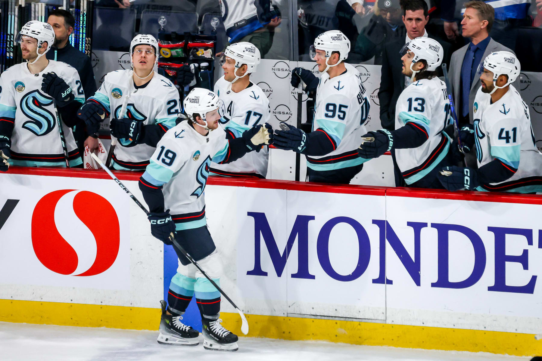 WINNIPEG, CANADA - MARCH 5: Jared McCann #19 of the Seattle Kraken celebrates his second period goal against the Winnipeg Jets with teammates at the bench at the Canada Life Centre on March 5, 2024 in Winnipeg, Manitoba, Canada. (Photo by Jonathan Kozub/NHLI via Getty Images)