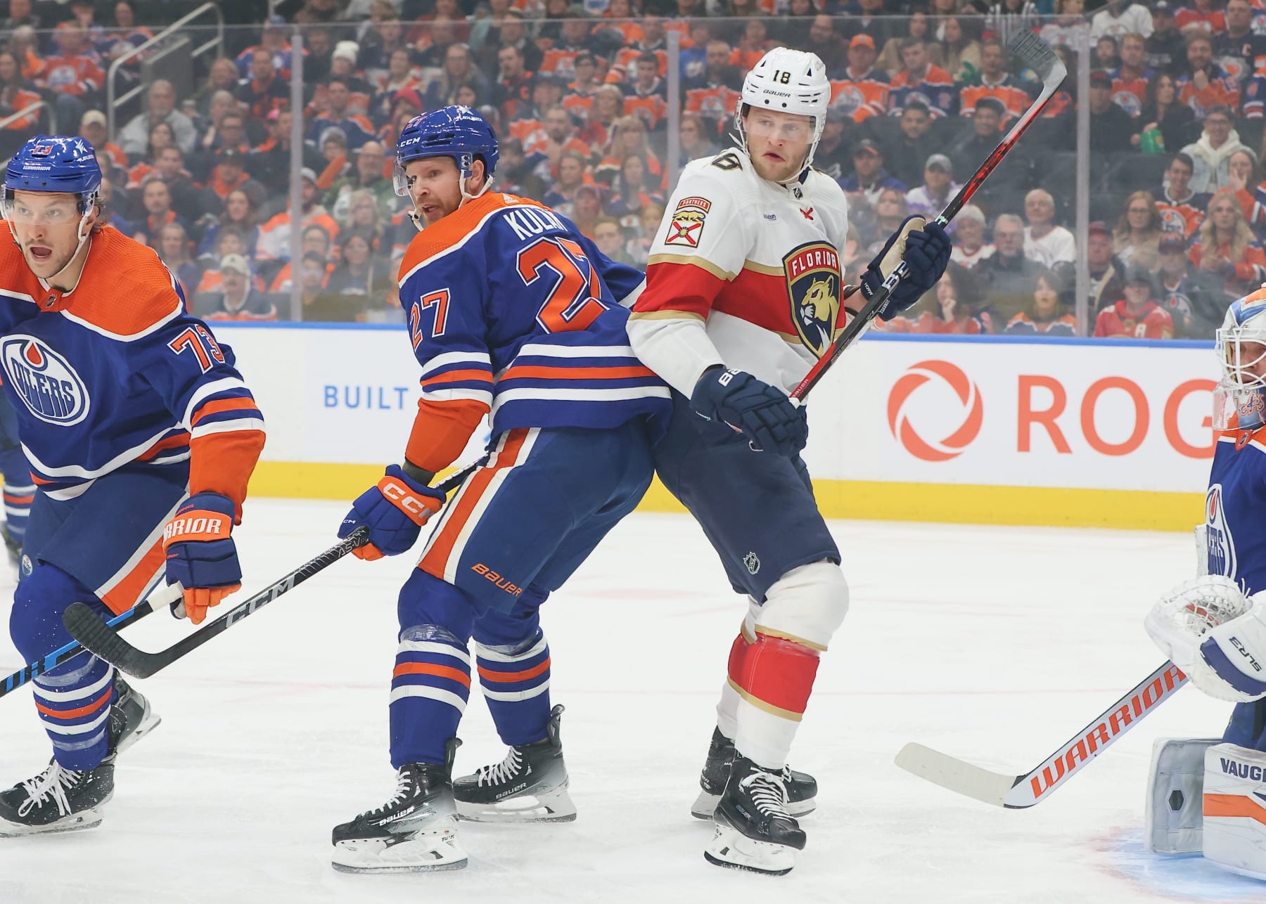 EDMONTON, CANADA - DECEMBER 16: Brett Kulak #27 of the Edmonton Oilers battles with Steven Lorentz #18 of the Florida Panthers in the first period on December 16, 2023 at Rogers Place in Edmonton, Alberta, Canada. (Photo by Lawrence Scott/Getty Images)