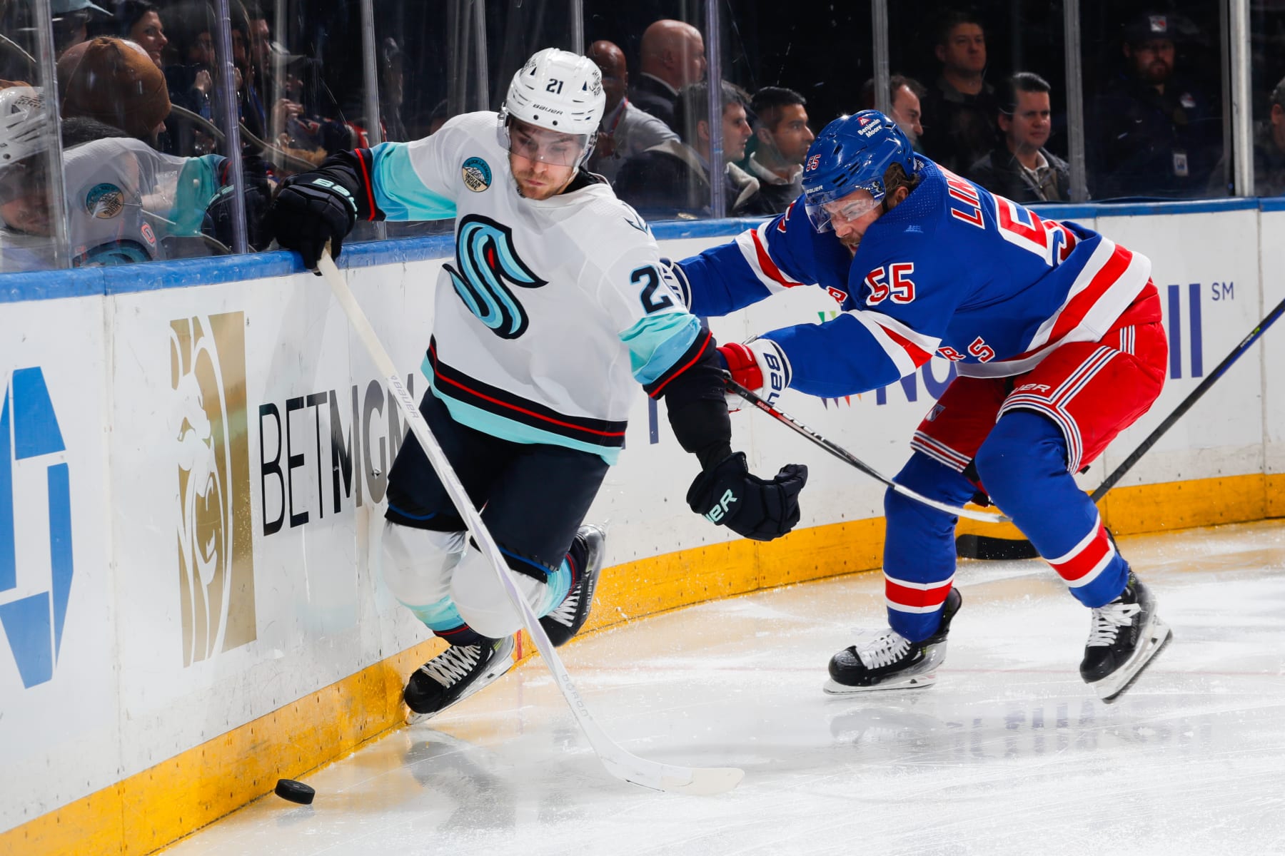 NEW YORK, NEW YORK - JANUARY 16:  Ryan Lindgren #55 of the New York Rangers defends against Alex Wennberg #21 of the Seattle Kraken at Madison Square Garden on January 16, 2024 in New York City. (Photo by Jared Silber/NHLI via Getty Images)