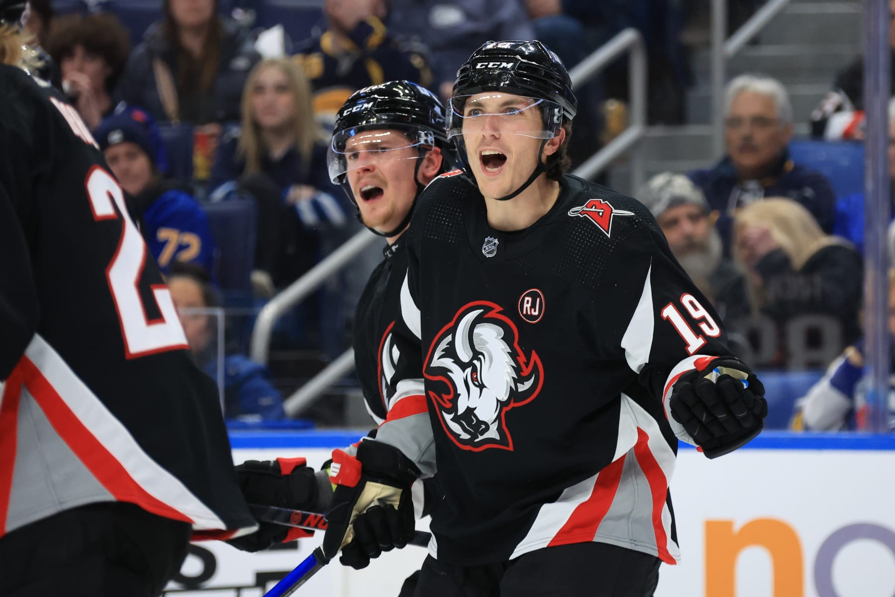 BUFFALO, NEW YORK - MARCH 3: Henri Jokiharju #10 and Peyton Krebs #19 of the Buffalo Sabres react to a penalty call during an NHL game against the Winnipeg Jets on March 3, 2024 at KeyBank Center in Buffalo, New York. (Photo by Bill Wippert/NHLI via Getty Images)