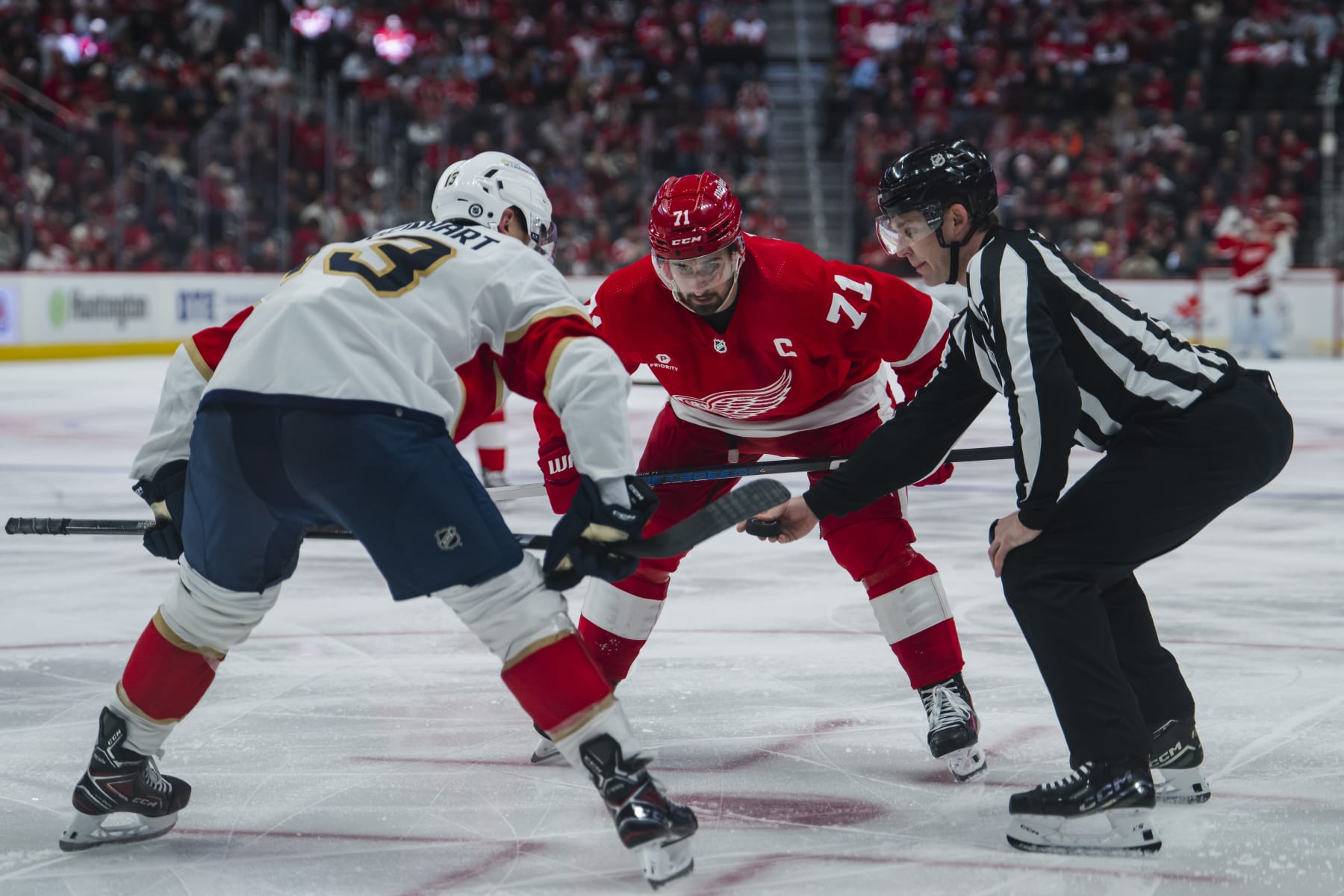 DETROIT, MI - MARCH 02: Dylan Larkin #71 of the Detroit Red Wings faces off against Sam Reinhart #13 of the Florida Panthers during the third period at Little Caesars Arena on March 2, 2024 in Detroit, Michigan. Florida defeats Detroit 4-0. (Photo by Darren Clark/NHLI via Getty Images)