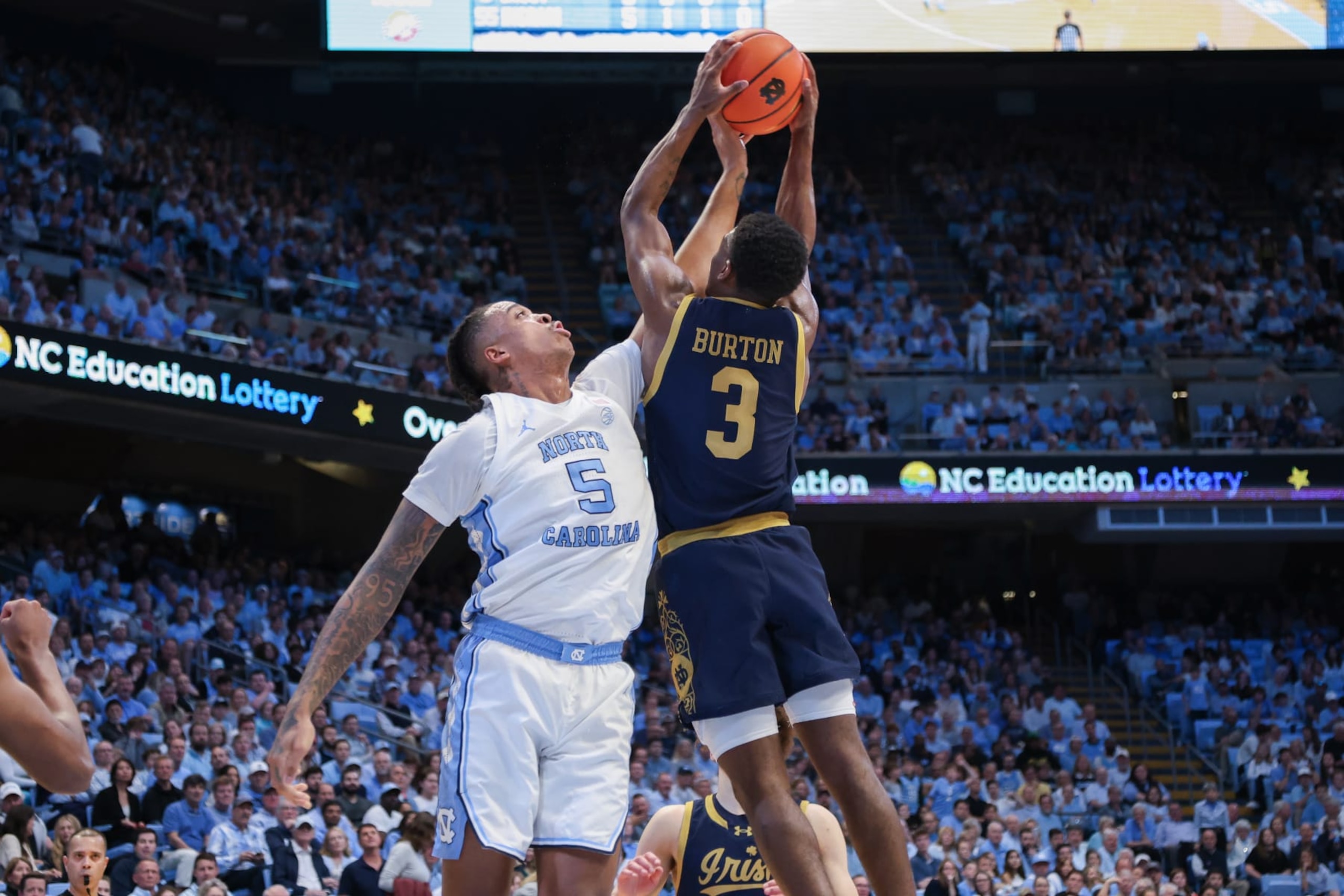 CHAPEL HILL, NC - MARCH 05: North Carolina Tar Heels forward Armando Bacot (5) bats away the rebound from Notre Dame Fighting Irish guard Markus Burton (3) during the college basketball game between the North Carolina Tar Heels and the Notre Dame Fighting Irish on March 5, 2024 at the Dean Smith Center in Chapel Hill, NC. (Photo by Nicholas Faulkner/Icon Sportswire via Getty Images)