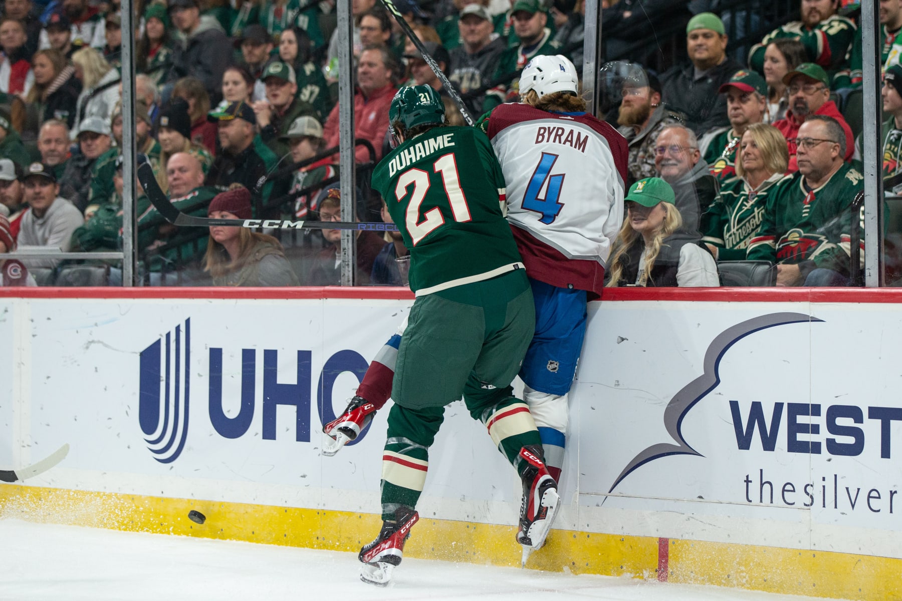 SAINT PAUL, MN - OCTOBER 17: Minnesota Wild Right Wing Brandon Duhaime (21) checks Colorado Avalanche Defenceman Bowen Byram (4) into the boards during the NHL game between the Colorado Avalanche and Minnesota Wild on October 17th, 2022, at Xcel Energy Center in Saint Paul, MN. (Photo by Bailey Hillesheim/Icon Sportswire via Getty Images)