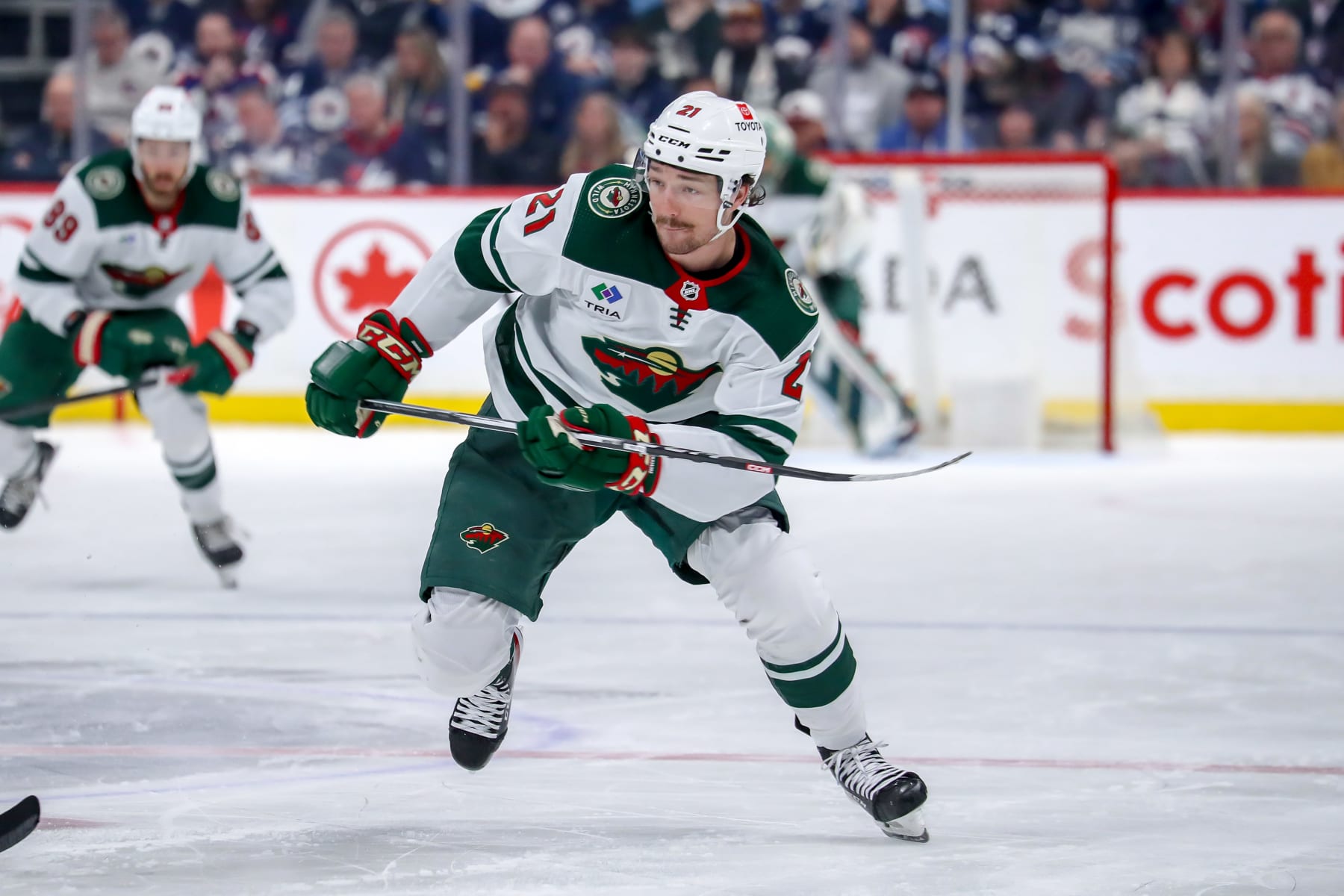 WINNIPEG, CANADA - FEBRUARY 20: Brandon Duhaime #21 of the Minnesota Wild follows the play down the ice during third period action against the Winnipeg Jets at the Canada Life Centre on February 20, 2024 in Winnipeg, Manitoba, Canada. The Jets defeated the Wild 6-3. (Photo by Darcy Finley/NHLI via Getty Images)