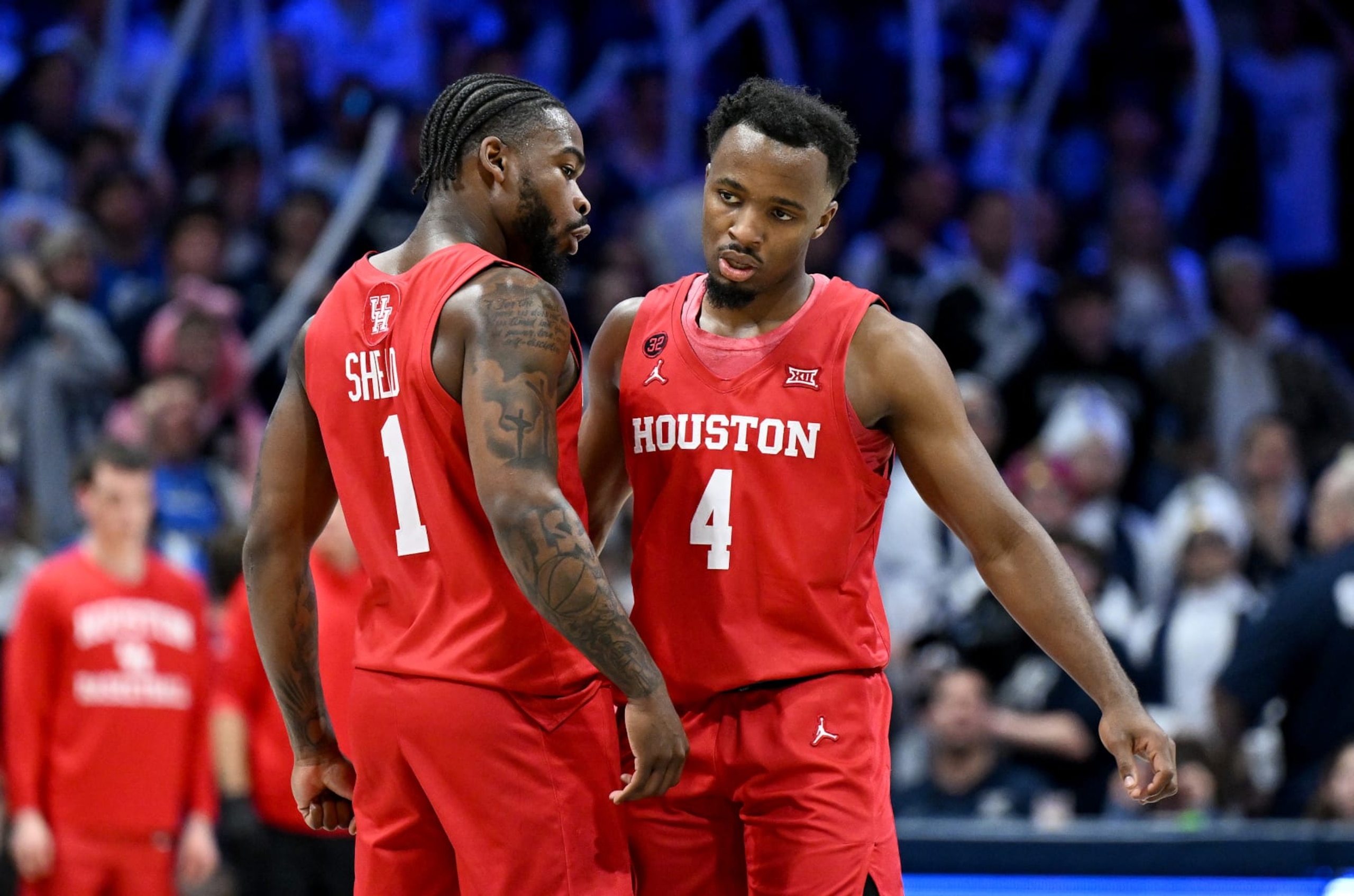 CINCINNATI, OHIO - DECEMBER 01: LJ Cryer #4 of the Houston Cougars celebrates with Jamal Shead #1 during the game against the Xavier Musketeers at Cintas Center on December 01, 2023 in Cincinnati, Ohio. (Photo by G Fiume/Getty Images)
