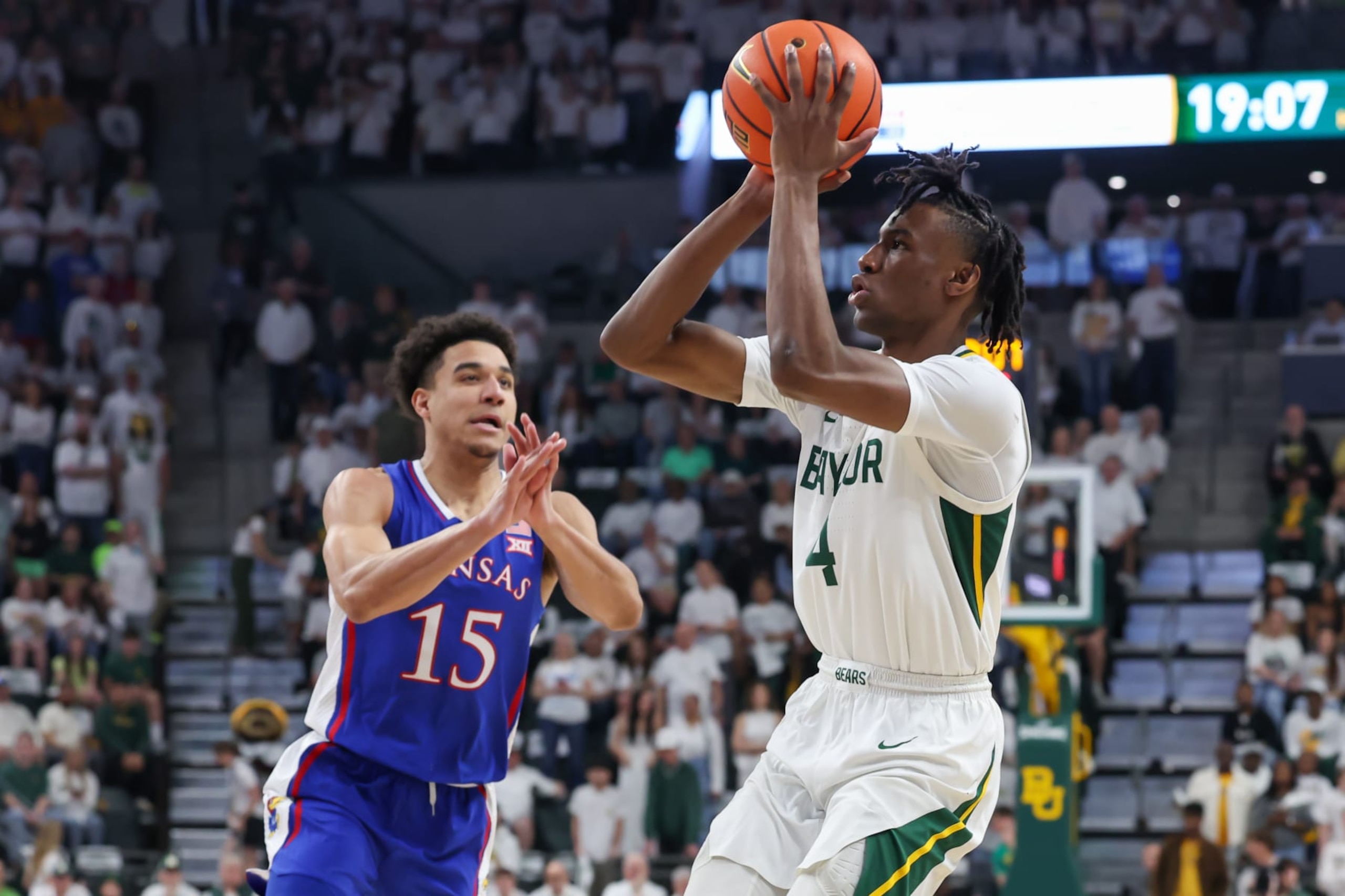 WACO, TX - MARCH 02: Baylor Bears guard Ja'Kobe Walter (4) takes a shot while being guarded by Kansas Jayhawks guard Kevin McCullar Jr. (15) during the Big 12 college basketball game between Baylor Bears and Kansas Jayhawks on March 2, 2024, at Foster Pavilion in Waco, TX. (Photo by David Buono/Icon Sportswire via Getty Images)
