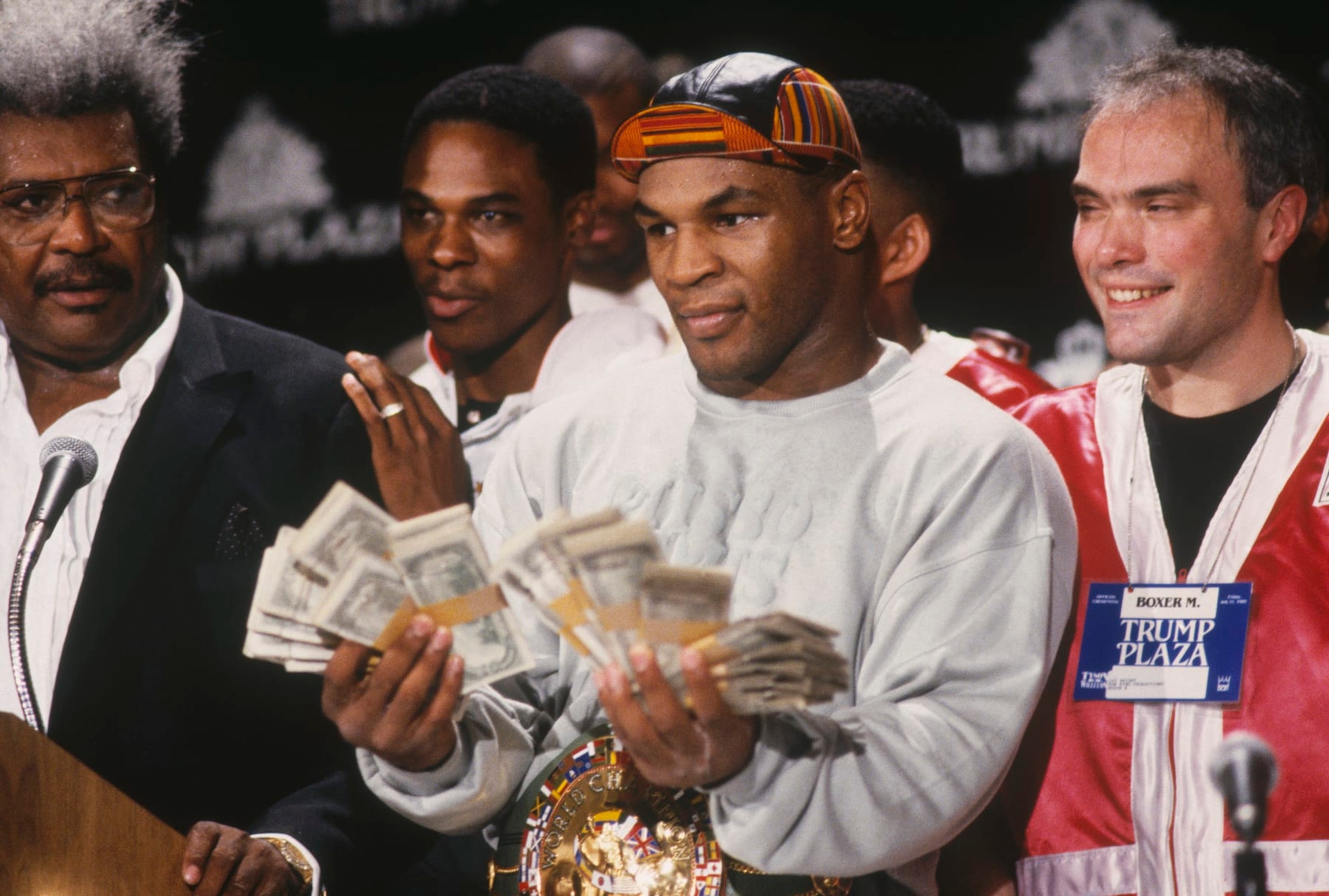 UNDATED: Mike Tyson holds two fists full of money and poses for cameras next to Don King during a press conference. (Photo by Focus on Sport/Gettty Images) UNDATED: Mike Tyson holds two fists full of money and poses for cameras next to Don King during a press conference. (Photo by Focus on Sport/Gettty Images)