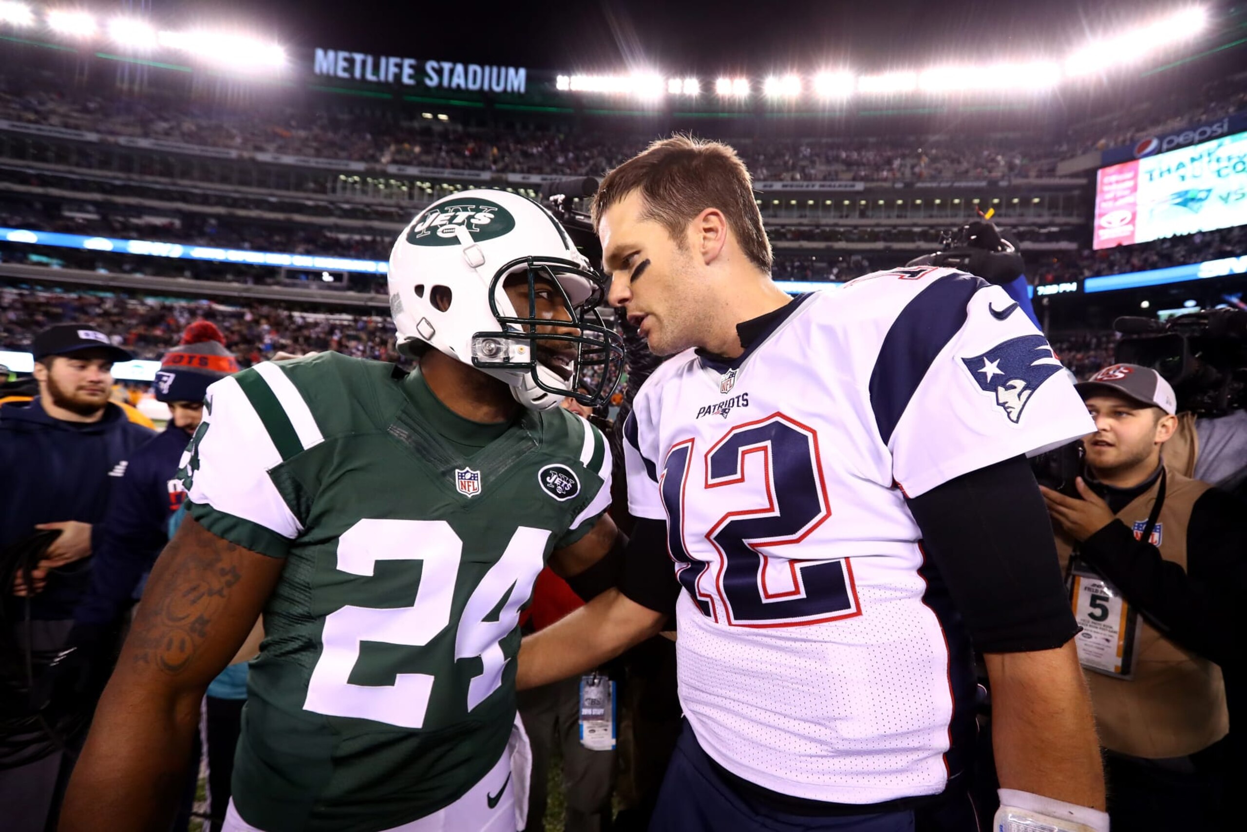 EAST RUTHERFORD, NJ - NOVEMBER 27:  (L-R) Darrelle Revis #24 of the New York Jets talks with Tom Brady #12 of the New England Patriots after their game at MetLife Stadium on November 27, 2016 in East Rutherford, New Jersey.  The New England Patriots defeated the New York Jets with a score of 22 to 17.  (Photo by Al Bello/Getty Images)