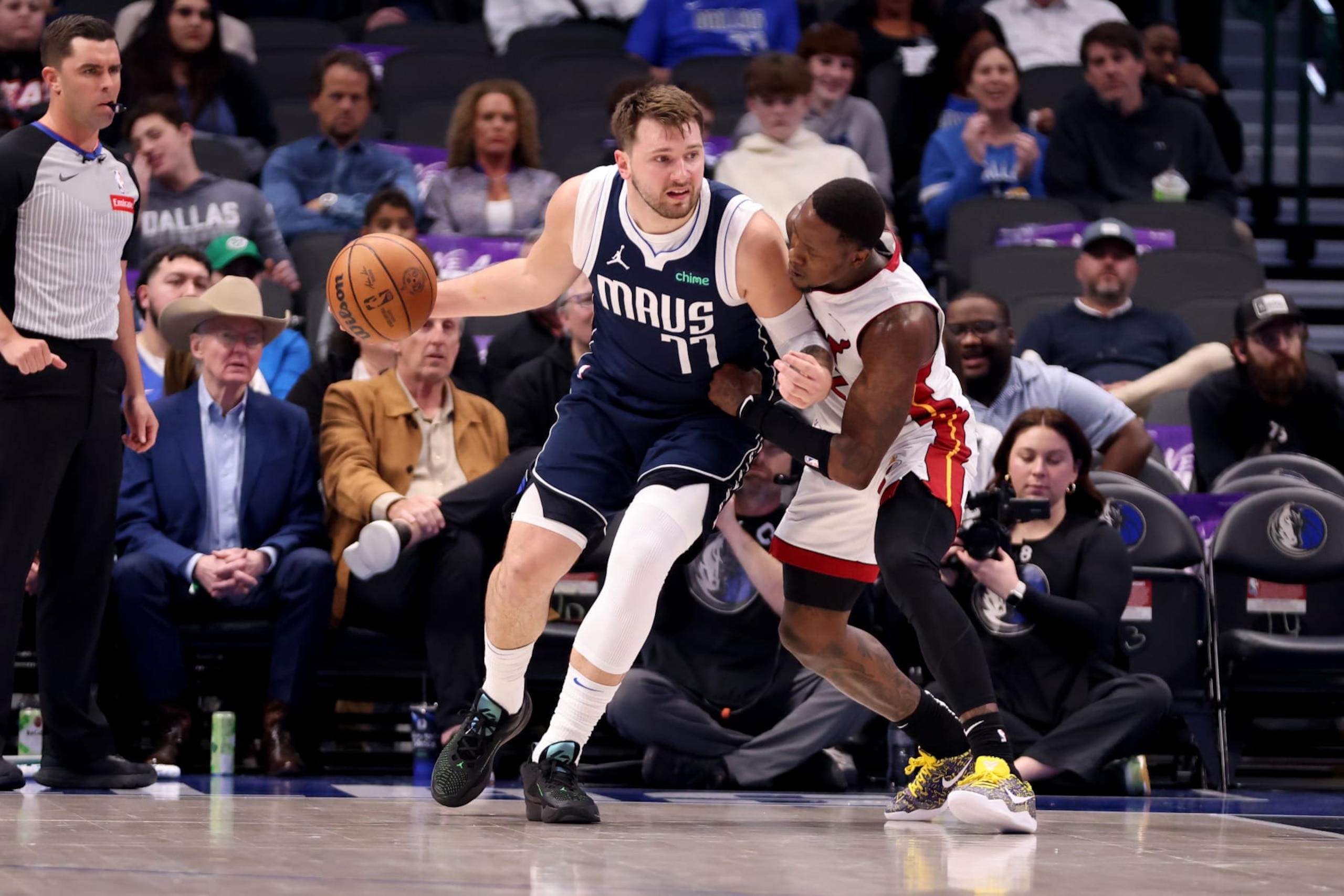 DALLAS, TEXAS - MARCH 07: Luka Doncic #77 of the Dallas Mavericks dribbles the ball against Terry Rozier #2 of the Miami Heat in the first half at American Airlines Center on March 07, 2024 in Dallas, Texas.  NOTE TO USER: User expressly acknowledges and agrees that, by downloading and or using this photograph, User is consenting to the terms and conditions of the Getty Images License Agreement. (Photo by Tim Heitman/Getty Images)