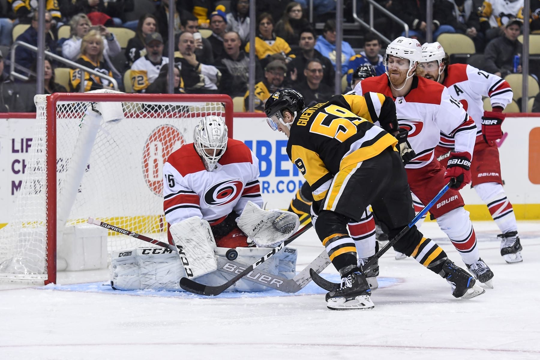 PITTSBURGH, PA - MARCH 31: Carolina Hurricanes Goalie Curtis McElhinney (35) makes a save on Pittsburgh Penguins Left Wing Jake Guentzel (59) in front during the second period in the NHL game between the Pittsburgh Penguins and the Carolina Hurricanes on March 31, 2019, at PPG Paints Arena in Pittsburgh, PA. (Photo by Jeanine Leech/Icon Sportswire via Getty Images)
