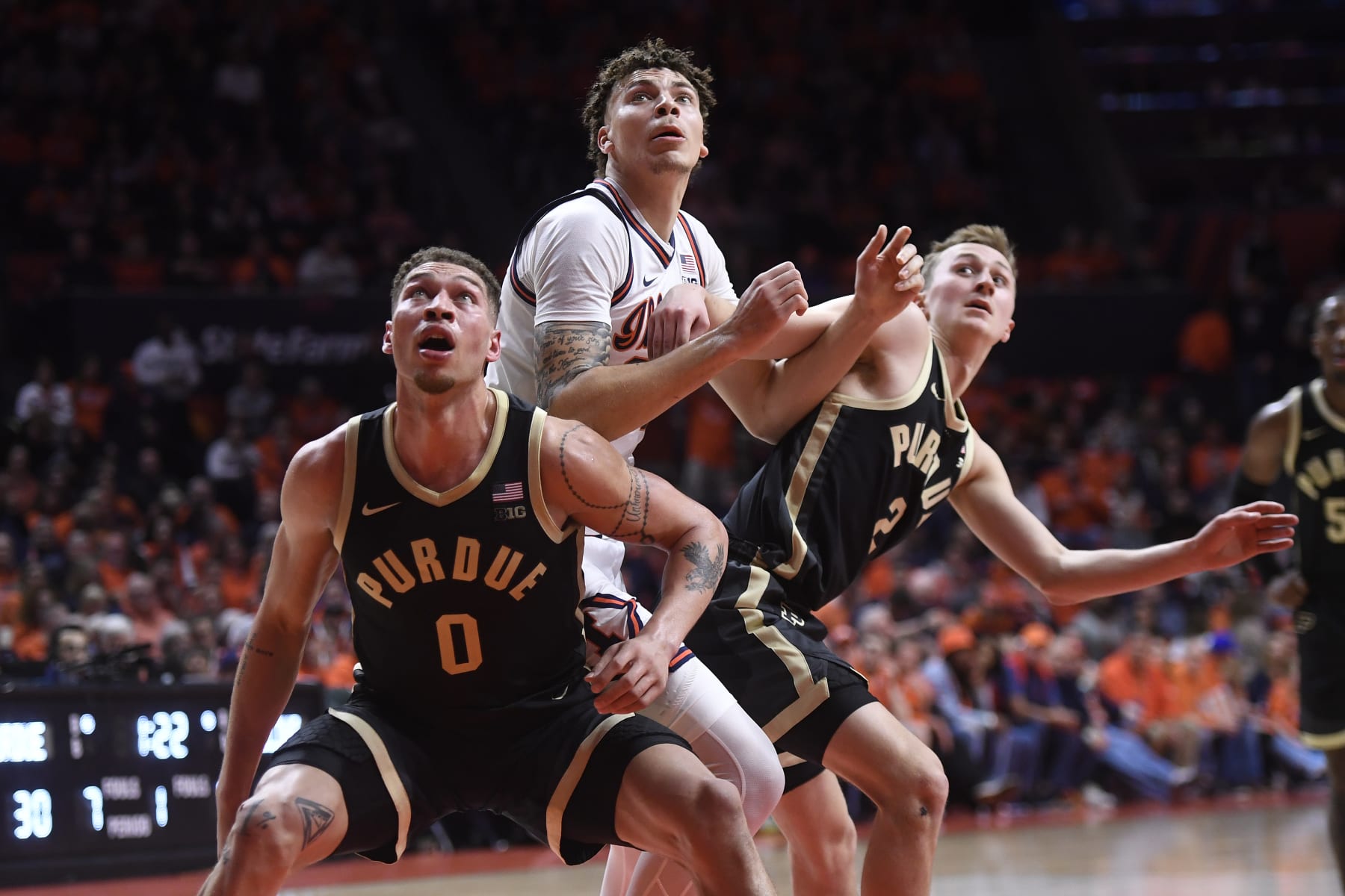 CHAMPAIGN, IL - MARCH 05: Purdue Boilermakers Forward Mason Gillis (0) and Purdue Boilermakers Guard Fletcher Loyer (2) battle with Illinois Fighting Illini Forward Coleman Hawkins (33) for a rebound during the college basketball game between the Purdue Boilermakers and the Illinois Fighting Illini on March 5, 2024, at the State Farm Center in Champaign, Illinois. (Photo by Michael Allio/Icon Sportswire via Getty Images)